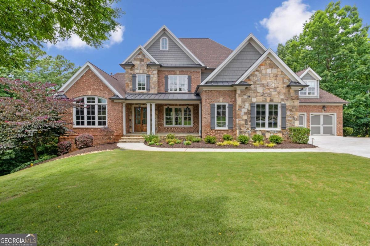 Gorgeous custom estate home in the gated Edinburgh, Jack Nickolas Bear's Best golf community. Designer and builder touches are evident throughout the home, making it truly unlike any other. Located on just under 2 acres with breathtaking views from the expansive double decks, all along the tree line, creates a sense of peace and privacy. The inviting rocking chair front patio leads you through double doors into a gracious, flowing floor plan; from the high ceilings to the extensive trim details in every room. The main level features an oversized office with beautiful views of the front yard and board-and-batten wall paneling. The formal dining room features a custom, built-in butler's pantry. Retreat to the main level owners' suite, complete with a sitting area, tray ceilings, a door to the rear deck, a spa-like bathroom featuring a freestanding tub and floor-to-ceiling cabinetry, as well as an oversized custom closet. The formal living room has it all: built-ins, coffered ceiling, cast stone-like gas fireplace, and views through the private back deck into the lush woods. The bright gourmet kitchen is complete with a gorgeous steel hood, abundant cabinetry with inserts and drawer organizers, oversized island, coffee bar, large walk-in pantry, and breakfast room. All of this, overlooking the oversized yet cozy, eye-catching keeping room with a vaulted wood-beamed ceiling, stone fireplace, and built-in bookcases. Tucked away are two 2-car garages and a large driveway turn-around with two Tesla chargers and extended height doors. The garages flow through the mudroom, complete with laundry room and powder room. Head upstairs to 3 en-suite bedrooms plus a media/ study room with views for miles. The terrace level is an entertainer's dream: a second kitchen with custom cabinetry, sink, refrigerator, wine refrigerator, microwave, and dishwasher, an over-sized game room, a designated theatre room with a high definition EPSON projector and a built-in 7.1 Dolby Digital surround sound system, two large living areas which include a family room with gas fireplace and built-ins, a powder room, as well as 2 bedrooms sharing a large double vanity, full bathroom and safe room. Venture outside to find expansive two-story decks, a fenced lush backyard, and a fire pit area. Cast music to any room or the whole house using your favorite streaming music app on the built-in stereo speaker system. Whole-house water filtration system and tankless water heaters. Commercial-grade Ubiquity internet access point/mesh system with four Wi-Fi access points throughout the house. Comcast and AT&T ready. Smart thermostats, doorbell, and automatic exterior light switches. Professional exterior landscape lighting. App-controlled permanent Holiday Lights along the roof line. Wired ADT security system. Last but certainly not least are the resort-style amenities, located in a highly rated school district, all within close proximity to everything your heart desires! Hot Tub Negotiable Less than 1 year old