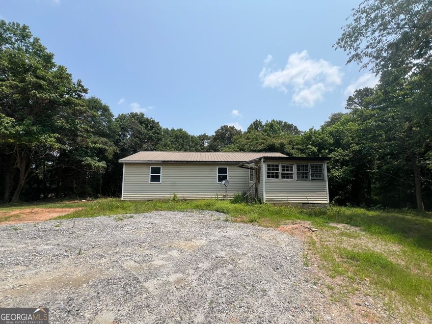 Unlock the potential of this 3 bedroom, 1 bath home nestled on a peaceful and private 1.2-acre lot in desirable Dawsonville, GA. Featuring a circular driveway and surrounded by nature, this property offers the perfect blend of seclusion and convenience-with no HOA restrictions to limit your vision! Whether you're looking to renovate the existing home or start fresh and build your dream home from the ground up, this expansive lot provides the space and flexibility to bring your ideas to life. Located just minutes from GA-400/US-19, the North Georgia Premium Outlets, and a variety of shopping and dining options, you'll enjoy both tranquility and accessibility. Sold as-is, this is a great opportunity for investors, builders, or anyone ready to create their own slice of paradise in North Georgia