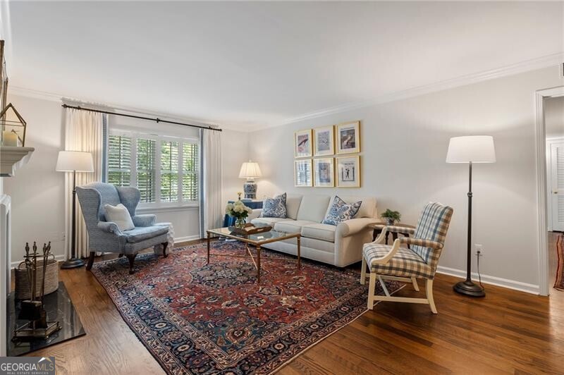 The one you've been waiting for! Immaculate, light-filled 3 bedroom, 2 bath condo with beautiful hardwood floors, timeless updates, and rare one-level living. One of the best features of this home is the open layout with not one, but two large living spaces. A formal living room is anchored by a wood-burning fireplace, and the oversized sunroom adds a more relaxed option for everyday living. An oversized primary suite has plenty of room for all your furniture, a generous closet and ensuite bathroom. Two full-sized guest rooms, each with nice closet space, offer great flexibility for roommates, guests, or home office setup. These rooms share an updated hall bath. The centrally located kitchen features white cabinets, NEW stainless steel appliances, and stone countertops and backsplash. Located just off the dining room and with a pass-through window to the sunroom, this setup makes entertaining a joy. The kitchen also features a built-in desk, pantry and side-by-side laundry plus storage. Cross Creek offers resort-style living with a par-3 golf course, tennis courts, pools, a fitness center, and an on-site restaurant and bar perfect for catching up with neighbors. Conveniently located near Buckhead, West Midtown, and major highways, providing easy access to everything Atlanta has to offer while still feeling like a peaceful retreat.