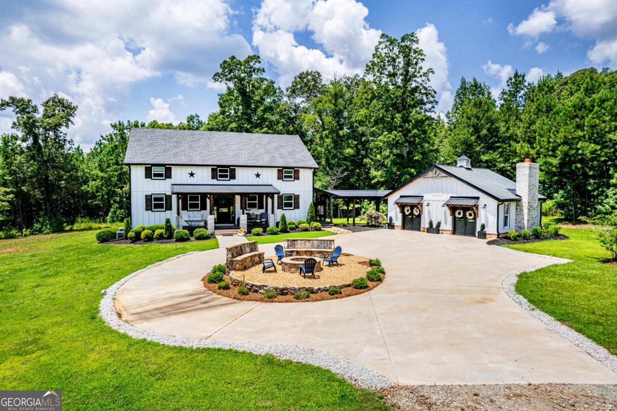 2021 Custom built, private 4,000 sf 4-3-1 farmhouse plus new separate recreation room with beautiful rustic bar and full shower/ bathroom and Chesterfield sofa bed. Fully furnished. New shooting range. House is in Greene County and Lake Oconee Academy (LOA) school district. Situated on 36+/-acres, with some pasture, and bordering 622 acres of National Forest. (Horses allowed and owner will accommodate through further renter negotiation) Towering vaulted ceilings with exposed beams and a massive masonry fireplace highlight the great room. Chef's kitchen with large quartz island/breakfast bar, stainless steel commercial 6 burner range, wall oven, microwave, dishwasher, refrigerator, custom milled shelving, custom cabinets and a farmhouse sink. Walk in pantry. Master suite with vaulted screened porch, dbl vanities, tile shower w/ river rock floor, copper soaking tub and a closet system. Second Screened porch with outdoor fireplace and swinging bed off dining area. Upstairs includes a bedroom with ensuite bath, laundry chute, plus 2 additional bedrooms with a shared bath and a huge hallway storage closet. Engineered hardwoods throughout. T&G pine walls and ceilings. Covered walk way. Mud room. Outdoor shower. Covered front porch. Encapsulated crawl space. 10 min to Madison/ Greensboro/Lake Oconee boat ramp. Less than 30 minutes to Athens. Air conditioned metal barn is not part of the lease and owner will continue to access purely for storage purposes.