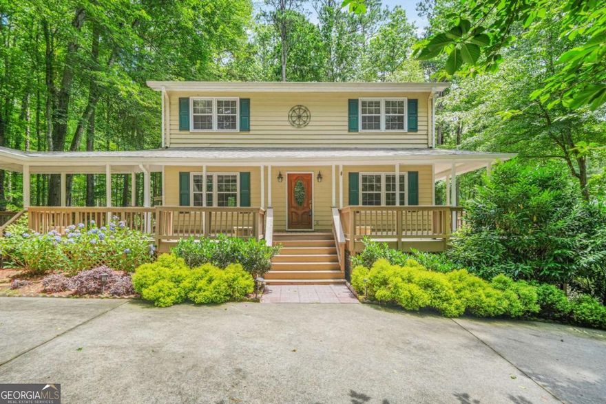 Lakeside oasis on 1.7, private acres in the heart of Marietta! Enter across the breezy, wraparound porch and turn to look across the private and beautifully landscaped front yard. Step through the front door to find the open concept living space, which offers an fireside family room, a formal dining room and an office that could be converted to an additional guest bedroom. Follow the hardwoods to the eat in kitchen with it's new, stainless stove and microwave, an abundance of knotty pine cabinetry and an eat in / breakfast area. Pass through the kitchen to yet another living space...an oversized great room with a vaulted ceiling and stacked stone fireplace. Make your way upstairs to the owner's suite with its updated ensuite bath. Two additional bedrooms and a full bath round out the upstairs. On the lower level, find another living and/or recreation space, including a large family room, guest space, plenty of finished and unfinished storage and a full bath with a new sink and shower. The best is still yet to come! Walk out onto the huge, screened back deck and look out over paradise. This is the best of outdoor living! Envision yourself enjoying morning coffee or an after work beverage on the enclosed porch and in the privacy of the trees, as you look out over your own, secluded lakefront. It doesn't get better than this. All of that and the peace of mind that comes with a new roof, new Aquaguard, gutter system and new garage door openers that go with the detached, two car garage. Don't miss the opportunity of enjoying your own, lakefront retreat in beautiful Marietta!