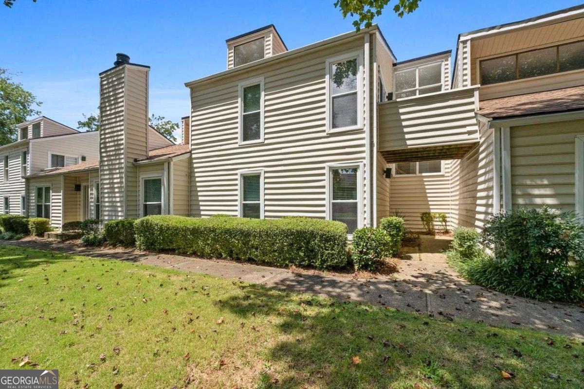 **Modern Comfort in Prime East Cobb Location - Sought-After Walton High School District** Step into this beautifully maintained 3-bedroom, 3 full bath townhome/condo in the heart of East Cobb, offering a stylish contemporary feel and spacious layout. The dramatic 2-story vaulted great room features soaring ceilings, a stunning stone fireplace, and tall windows that flood the space with natural light. The separate dining room is perfect for hosting, while the eat-in kitchen boasts stainless steel appliances and direct access to the covered 2-car carport, making everyday living a breeze. A large bedroom and full bath on the main level offer flexibility for guests, multigenerational living, or a home office. Upstairs, the oversized primary suite is a true retreat with a private balcony, updated en-suite featuring a double sink vanity, and generous closet space. The third bedroom is equally impressive with its own private full bath. Enjoy outdoor living on the large fenced deck-ideal for grilling, entertaining, or simply relaxing. The community offers two saltwater pools, tennis courts, and a clubhouse for added enjoyment. Conveniently located near shopping, dining, entertainment, and the Chattahoochee River, this home combines modern living with an unbeatable location. Zoned for top-rated Walton High School-this one won't last! **Seller is offering $5,000 in concessions** to be used toward closing costs, interest rate buy-down, or however the buyer chooses-giving you added flexibility and savings.