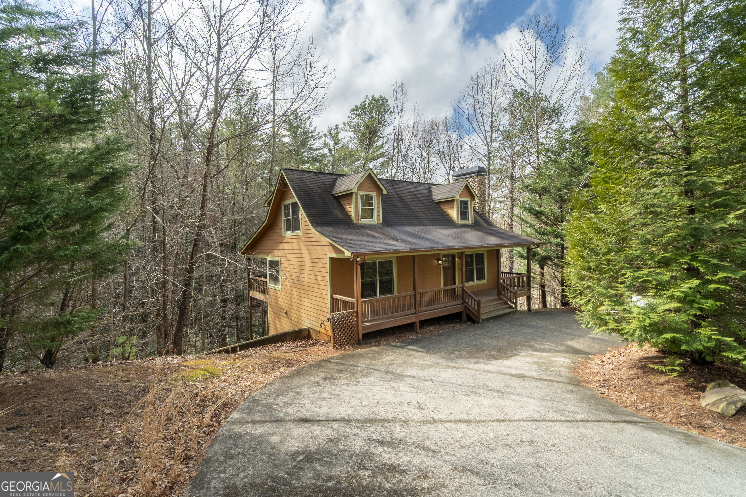 Traditional Mountain Cabin with natural wood walls and wood flooring. Currently utilized as a successful short term rental property, it is conveniently located inside the city limits of Helen. Enjoy a short walk to the banks of the Chattahoochee River! Yes, you are in town, but you will feel miles away with the privacy this home provides. 3 bedrooms (one on each level) and 3 full baths (one on each level) & one half bath (on lower level)! On the terrace level is a game room for plenty of entertainment with a billiard table and other activities. A large covered back porch is host to a very up to date, state-of-the-art hot tub that beckons you to hop in and relax and let your worries melt away! The front porch is a comfortable place to stay and watch the world go by as you relax behind a screen of cypress trees. Saving the best for last, you are sure to fall in love with the arrangement of the open Kitchen-Dining-Living area, complete with stone fireplace and comfortable seating in the living area, in front of the fireplace. This home is a dependable money maker with a proven rental history.... or use it for your private get-away or live here full time. It's a very pleasant walk into The City of Helen, to restaurants, shopping and entertainment venues. Make your appointment today!
