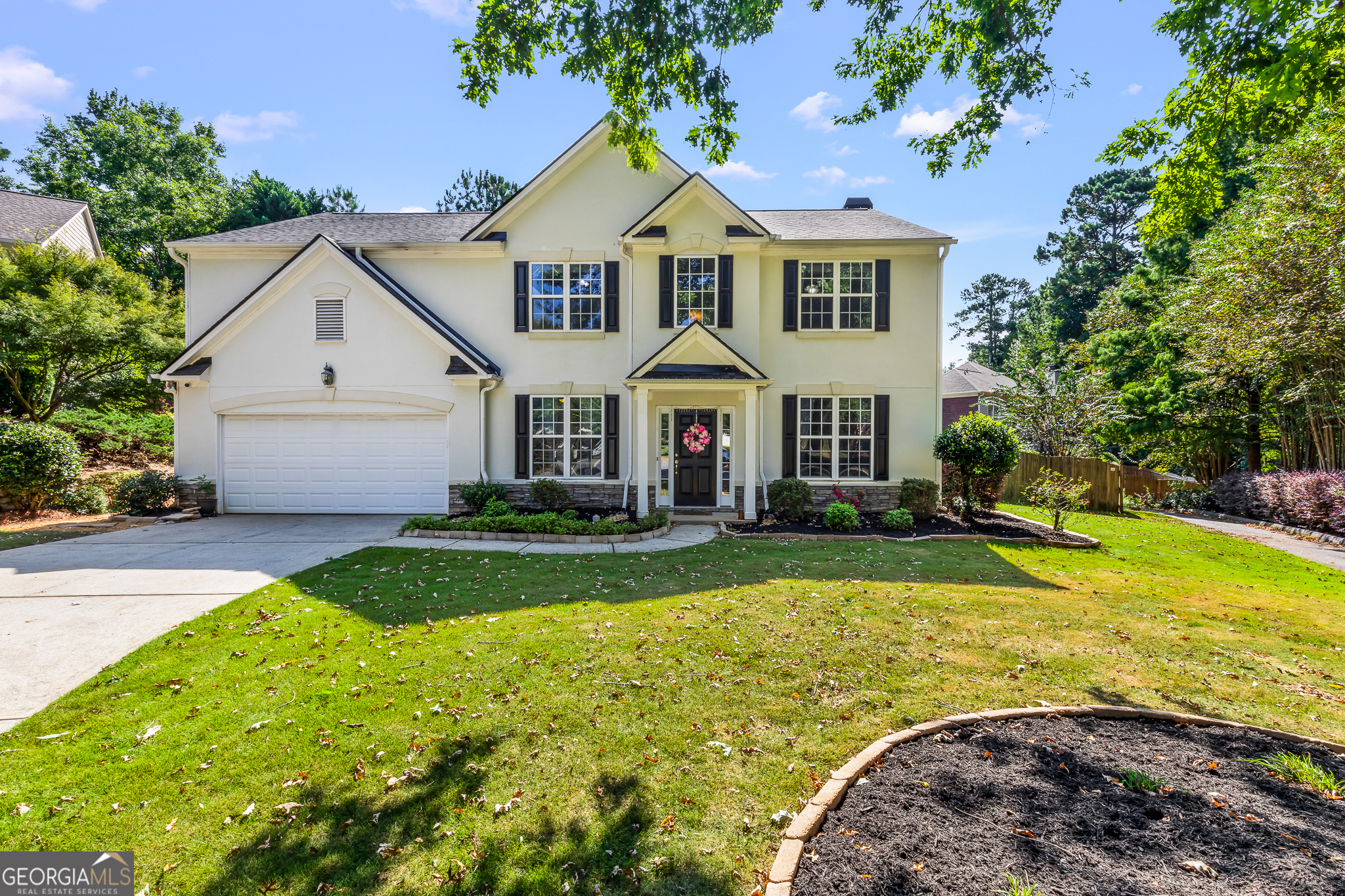 Welcome to this amazing 4-bedroom, 2.5-bathroom home located in the highly sought-after Wilshire Estates neighborhood of Peachtree City, located in a quiet cul-de-sac within the top-rated Starr's Mill School District. From the moment you arrive, the charming curb appeal will capture your attention. The freshly installed Zoysia sod and beautiful flower beds create a warm, inviting atmosphere before you even step inside. Step inside into a 2-story foyer that opens to a formal dining room and a flexible home office, ideal for a study, playroom, or media space. Sunlight pours through the home's tall windows, creating an open and airy ambiance throughout. The spacious great room features soaring ceilings, a floor-to-ceiling fireplace wall, and a nice flow into the kitchen-great for entertaining. The kitchen is equipped with abundant counter space, gas cooktop, built-in microwave, double wall ovens, and a generous pantry. The breakfast area connects to a laundry room with extra space for storage or your own custom mudroom setup. A stylish powder room on the main floor adds convenience for guests. Upstairs, you'll find four generously sized bedrooms, including a wonderful primary suite featuring a cozy sitting area. The bathroom features expansive walk-in closet with built-ins, and an updated spa-like feel with double vanities, private water closet, linen closet, and a beautifully tiled walk-in shower. The three additional bedrooms offer ample closet space and share an upgraded full bathroom with double vanities and a beautiful subway-tile tub/shower combo. Step outside to your private backyard retreat, complete with a stone-paved patio, charming pergola, and a hardwired hot tub-the perfect spot to unwind or entertain. The lush Zoysia lawn offers plenty of space to play, relax, or host gatherings. This home has it all-location, space, style, and upgrades. Don't miss your chance to make it yours. Schedule your showing today!