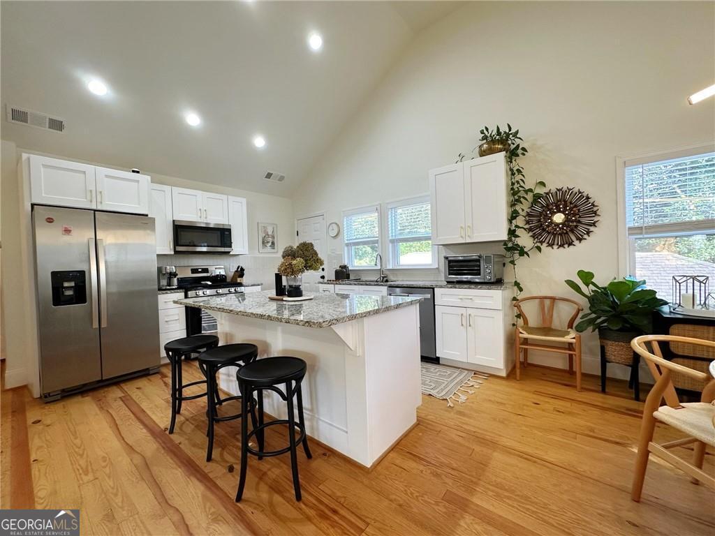 ELEGANT and BEAUTIFULLY renovated home with timeless details and MODERN UPGRADES throughout. VAULTED ceilings, CROWN MOLDING, and gleaming HARDWOOD floors frame a warm, inviting living space anchored by a CLASSIC wood-burning fireplace. The CHEF-INSPIRED kitchen boasts PREMIUM stainless steel appliances, granite countertops, and abundant cabinetry. Enjoy a LIGHT-FILLED sunroom and a PRISTINE private backyard with a FIRE PIT-perfect for relaxing or ENTERTAINING. FINISHED basement offers versatile FLEX space for an office, recreation, or guest suite. NO RENTAL RESTRICTIONS, making it ideal for investors or owner-occupants. Located in a wonderful area on a QUIET street, within WALKING distance to Mercedes-Benz Stadium and close to the Westside Beltline, Atlanta University Center, Downtown, and minutes to Hwy 20 & I-85. OWNERS ARE MOTIVATED - COME SCHEDULE YOUR SHOWING TODAY!