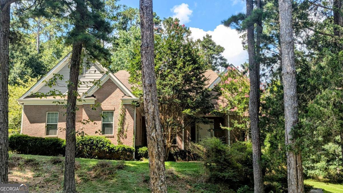 Tucked away on a wooded corner lot, this 3-bedroom, 2.5-bath home features vaulted ceilings in the living room and a cozy fireplace as the focal point. The kitchen overlooks a bright breakfast area, while the spacious master suite boasts tray ceilings, walk-in closets, a double vanity, and a separate tub and shower. Step outside to the back deck, perfect for relaxing or entertaining. A full unfinished basement offers endless potential for added living space or storage. **Agents: Please read private remarks/look at the offer guidelines in docs before calling, it should answer all questions you have.**