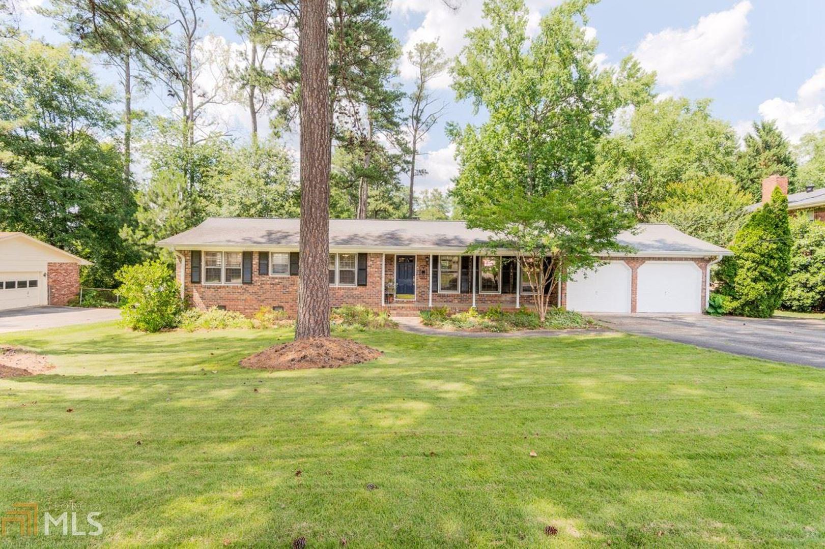 Stylish and sun-filled home nestled in the desirable Tuxedo Estates neighborhood of East Cobb. The spacious floor plan encompasses bright open living spaces, hardwood floors throughout, two guest bedrooms with updated Jack-Jill bath and a master suite with dual vanity and walk-in closet. The expansive kitchen boasts granite counters, stainless steel, abundant storage space and breakfast nook. A separate dining room comfortably seats 12+ guests and flows seamlessly into the ultra-cozy living room with brick fireplace and French doors providing access to the back yard. The oversized deck is perfect for casual entertaining with several sitting areas, firepit and views of the gorgeous level yard. The attached garage includes a finished bonus space ideal for a home office, practicing music or storage. Situated only moments from top-rated schools, shopping and restaurants, this home is a must-see!