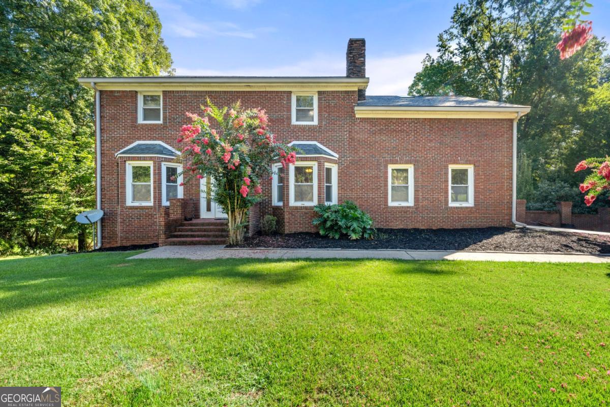 Nestled in Fayetteville's sought-after Whitewater school district, this beautifully renovated 4-bedroom, 3.5-bath steel-frame home offers 3,562? square?feet of living space on a waterfront lot. Built in 1989 and updated in 2016 and 2025, the two-story brick residence enjoys panoramic lake views and a sprawling yard where deer often wander. Inside, sunlight fills the open living and dining areas with hardwood flooring, while the modern kitchen features rich cabinetry, granite counters and stainless appliances. The main level includes a cozy family room, formal dining room and a convenient laundry, and upstairs you'll find spacious bedrooms with plush carpeting and beautifully updated bathrooms. A finished bonus room and unfinished basement provide flexible space for a home office, recreation or storage. Outside, a large deck overlooks the tranquil lake, and there's plenty of open lawn for outdoor games, gardening or simply soaking in the peaceful surroundings. With its durable steel construction, waterfront setting and assignment to highly rated Whitewater Middle and Whitewater High Schools this serene property is a rare opportunity to enjoy country-style living just minutes from town.
