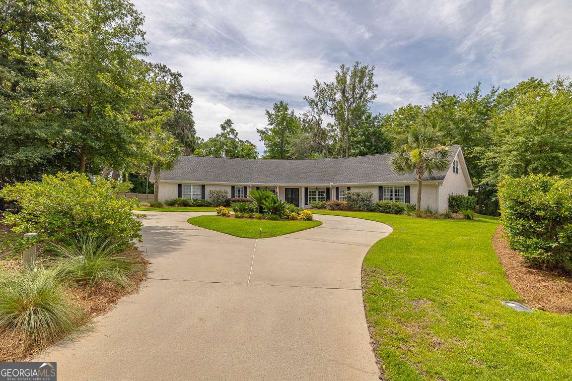 Discover your perfect retreat in this completely renovated four-bedroom, four bathroom home tucked away on a quiet cul-de-sac in the desirable Sea Palms West community. This stunning property sits on a private wooded lot, offering the perfect blend of seclusion and convenience. Upon entering, you will find an open layout with luxury vinyl plank flooring throughout the main level. The home features beautiful tongue and groove ceilings, elegant downlights, and custom Serena and Lily pendants and sconces that create warm, inviting spaces. Wood beam accents in the den and keeping room add rustic charm, while the bricked fireplace with reclaimed pine mantle serves as a focal point. The heart of the home showcases a newly designed custom kitchen with an island, custom cabinets, and stainless steel appliances. All bathrooms have been completely renovated with custom vanities and mirrors, including a fourth full bathroom in the upstairs bonus room with new carpet. Outside, you'll love the saltwater in-ground pool featuring a new filter, salt cell, and automatic refill system. Newly painted pavers, a waterfall, and surrounding wall create a resort-like atmosphere. Professional landscaping and architectural lighting enhance the property's curb appeal and evening ambiance. This home leaves nothing to be desired. Every detail has been carefully considered in this amazing renovation, from the open living spaces to the private outdoor oasis. It's move-in ready and waiting for you to call it home.