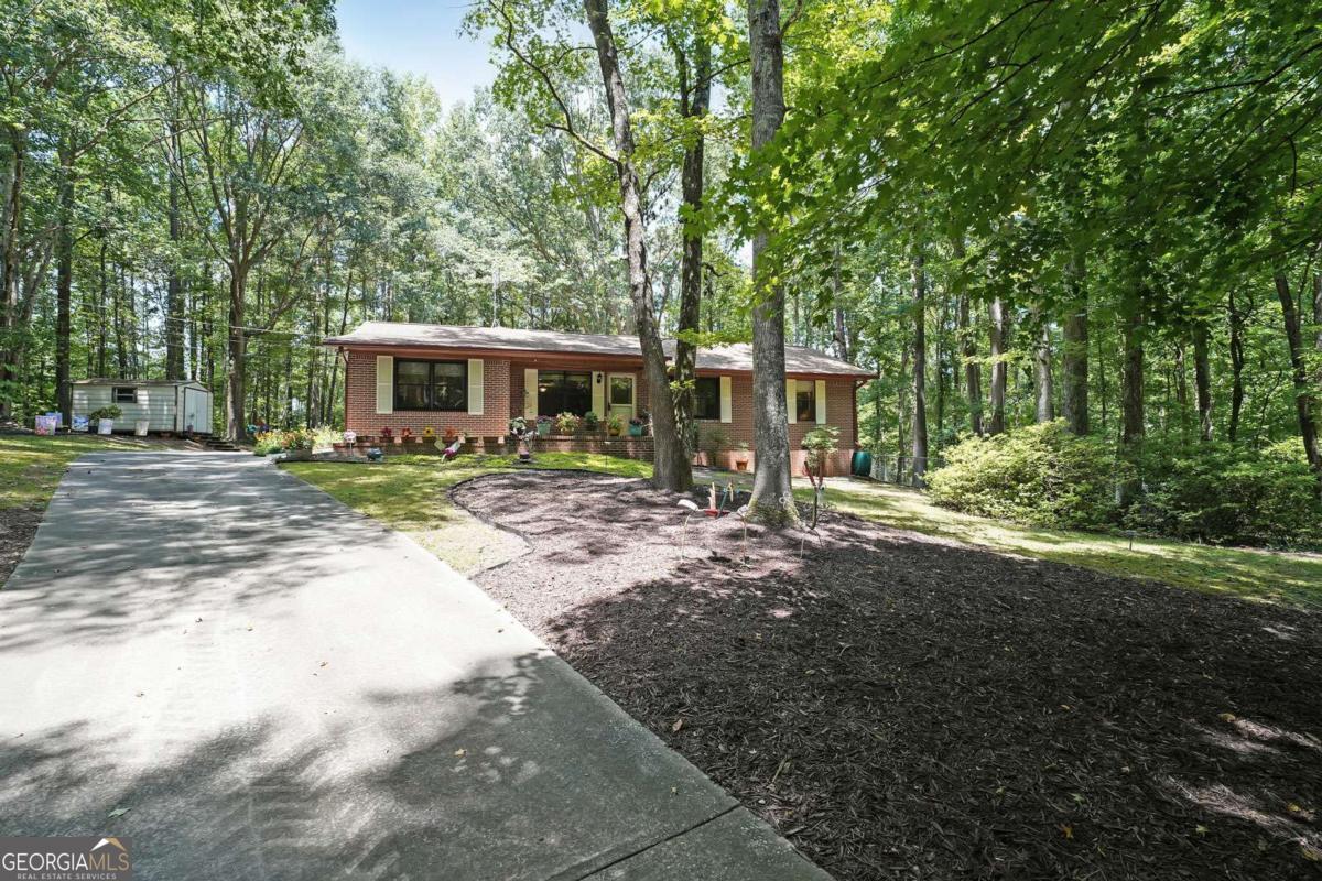 Welcome to this inviting ranch-style home, perfectly situated in a serene and private setting. Offering 3 spacious bedrooms, including an oversized primary suite, and 2 full baths, this residence combines comfort with functionality. The open-concept living and dining area create a warm and welcoming atmosphere, enhanced by durable LVP flooring, double-pane windows, and a recently installed roof. All of this is nestled on 5.68 acres. This property offers endless possibilities-whether you choose to enjoy its natural beauty or explore expansion opportunities. Conveniently located close to shopping, dining, and essential amenities, this home provides the perfect balance of peaceful living and accessibility.