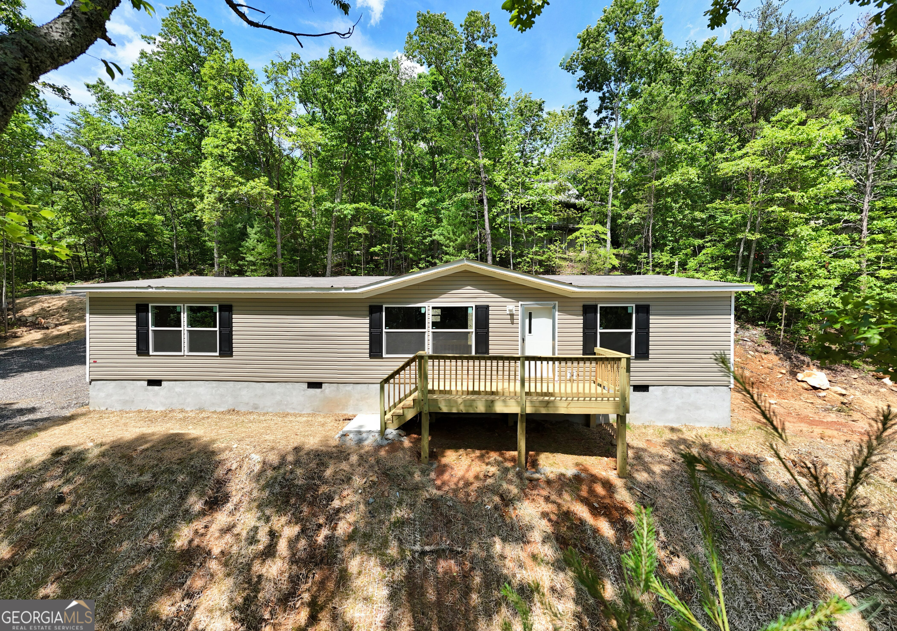 3BR-2BA Modern Mountain Retreat featuring breathtaking long-range views of the North Georgia Mountains. Embrace tranquil living in this brand-new Clayton Smart Home, nestled on a secluded wooded lot with picturesque mountain vistas. This thoughtfully modern designed 3Bedroom-2 Baths home features: Split floor plan - offering privacy and comfort. Smart Homebased Technology - including an Ecobee smart thermostat, smart water heater, and energy-saving comfort-efficient appliances. Stylish open-concept layout -perfect for gatherings and everyday living. Spacious kitchen with ample cabinetry and storage. Permanent foundation stability for financial options. Modern finishes throughout and ready for occupancy. Located 5 minutes_1.9 miles from downtown Blairsville, shopping-dining, Butternut Creek Golf Course, highly rated Union County Schools to our Union General Hospital's Premier Health System.