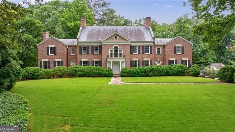 Truly a special opportunity to reimagine a classic 1930s residence, originally designed by renowned architects Frazier and Bodin, on one of Buckhead's most cherished streets-Blackland Road. Nestled on approximately 2.2 acres in the heart of Tuxedo Park, this well-preserved home sits gracefully on a rolling front lawn, offering timeless curb appeal, a pool, and a spacious grassy backyard. A grand foyer welcomes you inside, leading to generous living and entertaining spaces accented by high ceilings and elegant crown molding. The main level features a guest bedroom and full bath, perfect for hosting visitors. Upstairs, an intricate staircase leads to five bedrooms and four and a half baths, including an expansive primary wing with dual bathrooms and a serene sitting area. With endless potential for a transformative renovation, this home is a rare find on an exceptional lot. A must-see in Tuxedo Park.