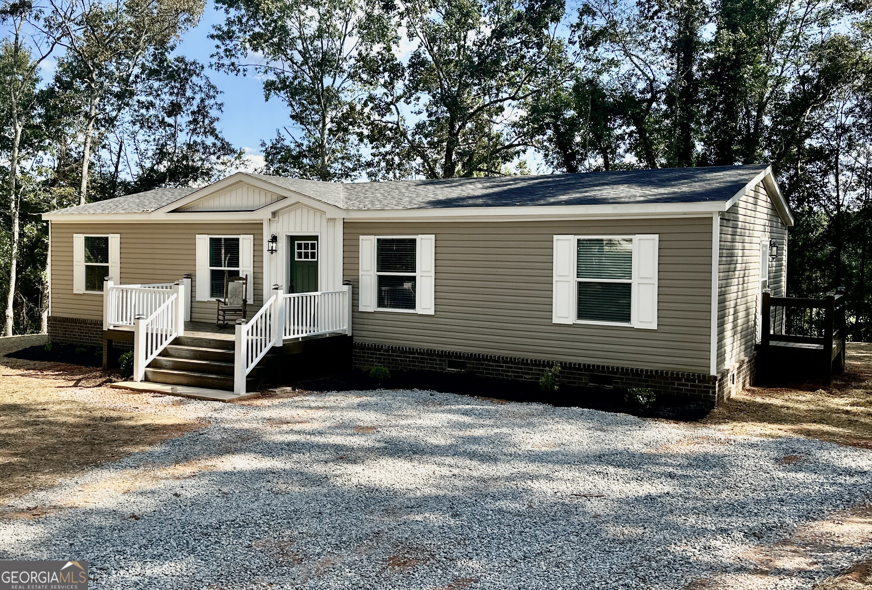 Another unique offering from Progressive Homes (PH); a premier land-home developer of Manufactured Homes in North Georgia- "Where Ordinary becomes Extraordinary. This sheet-rocked 3 bedroom, 2 bath home has an open floor plan and a large mud room with an area for an office space. It includes an all-brick permanent foundation, a heat pump, OSB wrapped exterior, custom stained decks, upgraded insulation, energy efficient windows, stainless-steel appliances, a remote-controlled electric fireplace, a programmable thermostat, and a double sliding door off the dining area leading to a custom-built deck. No expense was spared to provide a truly unique enhanced low-cost quality living experience. All Progressive Homes lots are graded to maximum use of your land, capture the best views, and provide for adding a garage or workshop where possible. This home meets all FHA, VA, and Conventional Finance Standards and includes a 1-year house warranty. See the attached pictures to view the details that distinguish a Progressive Home from others. See Plat, home is located on Lot 3. Tax records reflect the land only as home was not placed on property until 2025.