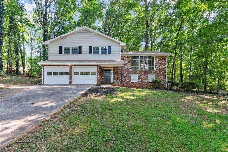 Charming split level 3 bedroom, 2.5 bath home located on quiet tree-lined cul-de-sac. A touch of mid-century modern feel with curved staircase and wrought iron railing leads up to spacious family room. Gorgeous, large picture window overlooks huge, wooded front yard. Exterior and interior is all freshly painted, new chrome light fixtures throughout, stainless newer fridge, and all brand new carpet throughout. Main level features wood burning fireplace in spacious bonus/family room and a half bath for guests.Upper level features master with dual closets, two secondary bedrooms, and hall bath. Lot is oversized and backyard is level with plenty of space for a garden, shed, or just for some peaceful, quiet time on the private deck. Fabulous home located in a great spot, close to shopping, schools, restaurants, and easy access to highway.