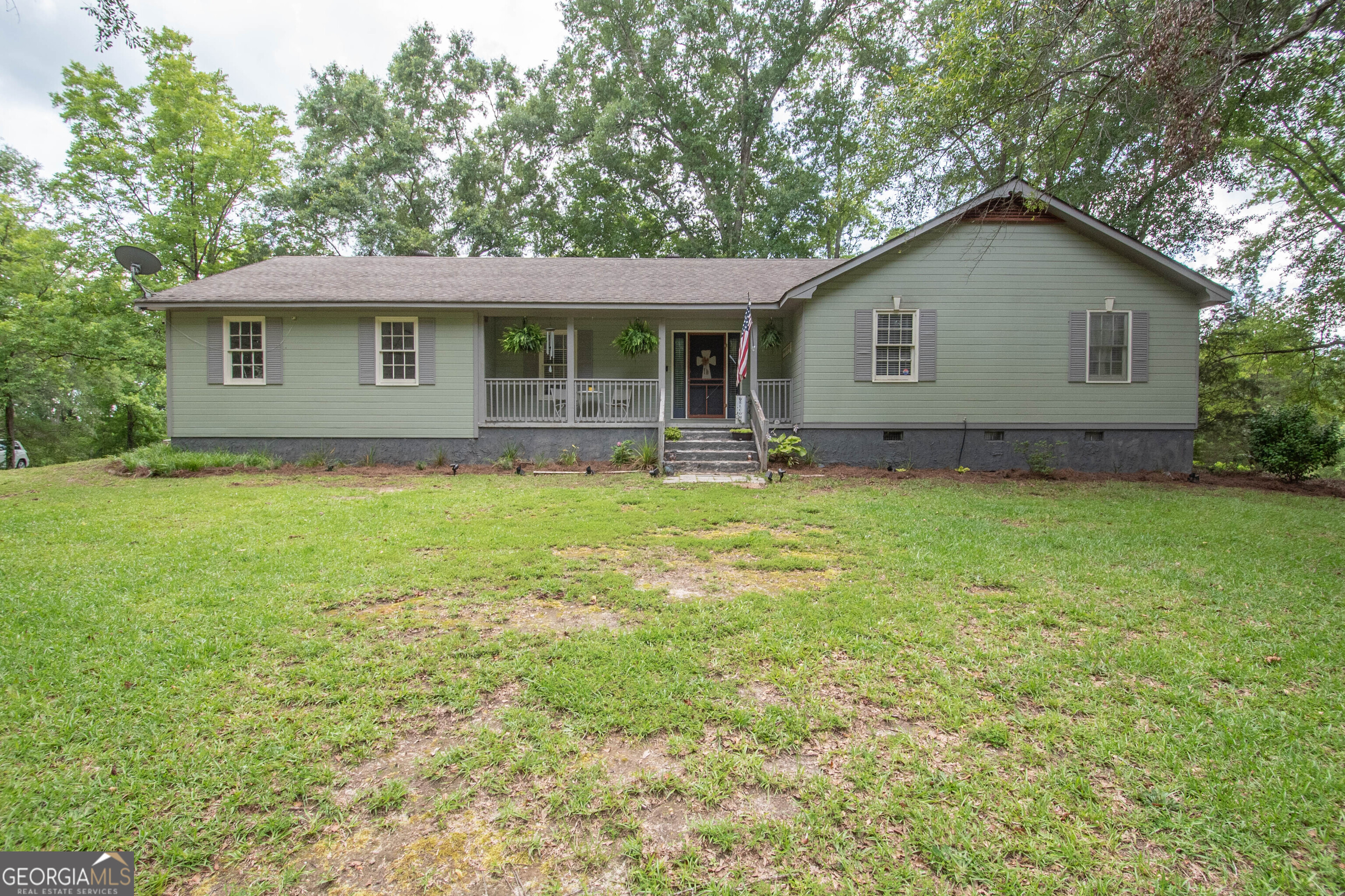 Located in the highly sought-after school district of Pike County, this charming ranch-style home offers the perfect blend of comfort, space, and privacy. Situated on a spacious 3-acre corner lot, the property features over 1,500 square feet of living space with 3 bedrooms and 2 full bathrooms. Enjoy peaceful mornings on the relaxing front porch and unwind in the evenings on the spacious back porch. The fenced-in yard adds both convenience and security, making it ideal for pets or outdoor activities. Inside, you'll find a large living room with a cozy fireplace, an eat-in dining area, and a separate formal dining room, perfect for entertaining or family gatherings. This home combines great location, ample space, and a warm, welcoming atmosphere.