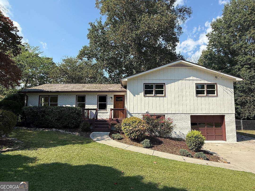 Beautifully updated home on a large private lot. Open plan with a vaulted great room featuring wood beams, a ceiling fan, and a fireplace. Recently renovated farmhouse-style kitchen w/ custom cabinetry, tile backsplash, solid surface counters, and stainless steel appliances. Large private fenced lot. Screened-in porch and deck overlook the wooded backyard.