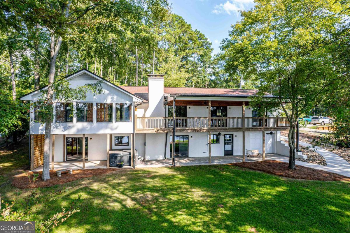 Your Lake Sinclair Retreat Awaits- Tucked away on a peaceful 1.81-acre lot with deep water frontage, this 4-bedroom, 3-bath fee simple home is a hidden gem, offering the perfect blend of comfort, space, and lakefront charm-all priced under $900k. Boasting over 3,300 sq ft with stunning lake views from every room and spacious interiors, this home is ready to be enjoyed just as it is or transformed into your dream lake getaway. Conveniently located between Eatonton and Milledgeville, you'll enjoy the serenity of lake life with shopping, restaurants, and local community events just minutes away. Wake up to wide-water views, spend your days on the dock, and unwind in a home designed for relaxation and gathering with family and friends. This is a true lakeside retreat with room to breathe, space to grow, and memories to make that will last a lifetime. One year home warranty to Buyer at close!