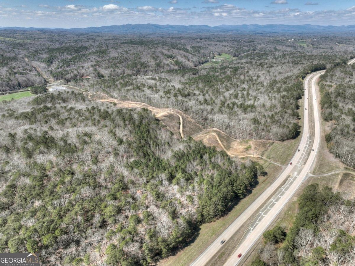 Attention Developers & Investors! 135+ ACRES with over ONE MILE of Highway 515 frontage! Located approximately 5 miles south of the thriving commercial sector of the East Ellijay shopping district. Endless opportunities for this property. Convenient to Ellijay and Jasper. Property is gentle with all usable land. Possible options: The Highway 515 frontage could be developed as commercial and the remaining acreage could be zoned for residential. Property is currently zoned A1 and in land conservation. There's also a Georgia Power easement on the property.