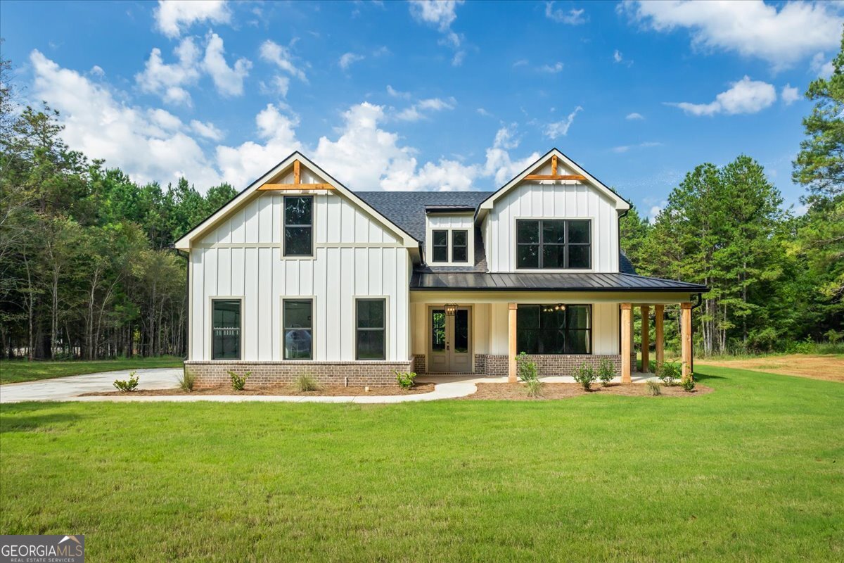 Builder is offering a 4.99% interest rate! Don't miss the chance for this new construction home in Social Circle school district. This new construction built by Rockin L Homes features a beautiful craftsman style with luxury touches. This layout is everything you need. This home features 4 bedrooms, 3.5 baths with master on the main. As you enter the home, you will immediately notice the open concept and tall ceilings making this home feel so spacious! The kitchen is a dream, with a large island perfect for entertaining, all appliances are stainless steel and include a black cooktop, vent hood, built-in microwave, and built-in oven and dishwasher. This kitchen also has ample amount of cabinets. There is also a large walk-in pantry. This home features LVP flooring throughout. As we go to the owner's suite on the main, let's talk about the beautifully designed owner's bathroom with soaking tub and floor to ceiling spacious tiled shower, double vanity, and separate toilet room, also the owners walk-in closet does not disappoint on space. Upstairs, you will find three additional bedrooms, all perfect size for family or guest. Guest bathroom, features double sinks and tub shower combo. Now let's go outside and have a look at this open lot on over 5 acres, the covered patio is right off of the living room, which is perfect for your gatherings. Taxes are accurate until bill comes out.