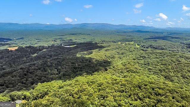 At 5.35 +/- acres, you can build just about any home. This lot is very private, sits way up high and flattens out up top to a beautiful building spot with a babbling creek and waterfalls. Creeks border both sides. If tranquility is what you are looking for, then look no further. Minimum sf is 3500 above grade. This lot can be a slab, walk out back yard with side daylight basement or a walk out basement.