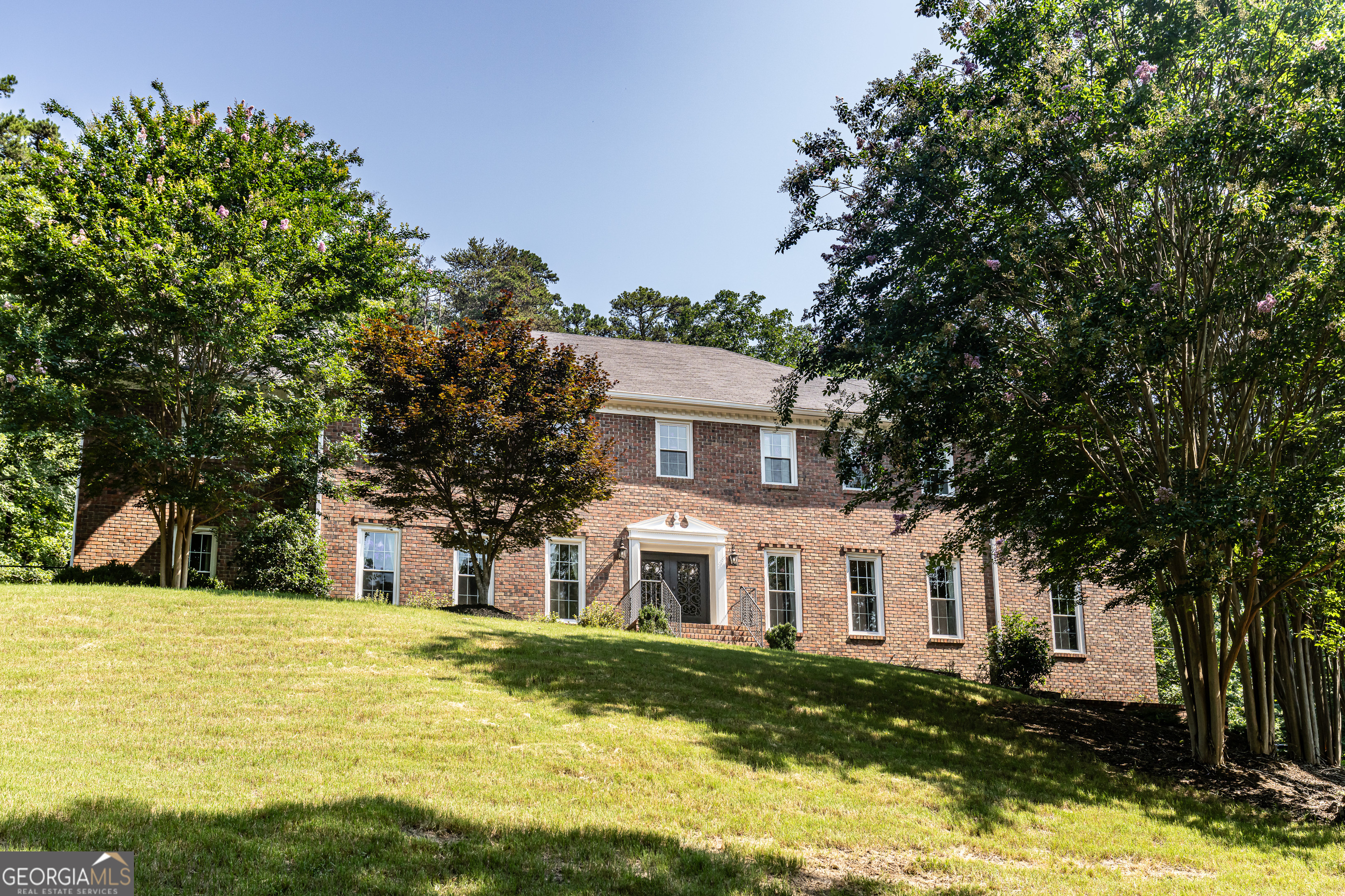 Looking for land and privacy without leaving the city? This classic brick home is nestled at the edge of the Marshall Forest, offering serenity, seclusion, and convenience. A long, winding newly widened and asphalted gated driveway leads you to your own private retreat. First glance see the brand new roof! Newly enlarged parking area and play area with new sod!!! Inside, you'll find 6 spacious bedrooms - possibly up to 8, with two primary suites (one on each level). Need flexibility? There's a large workout room and a study upstairs that can easily serve as additional bedrooms or bonus rooms. The updated kitchen features all the modern upgrades you expect, and all bathrooms have been stylishly refreshed. Entertain with ease in the huge separate dining room, a formal living room (or potential office), and a precious breakfast nook with peaceful views of the forest. Enjoy outdoor living on the new oversized deck or relax year-round in the sun room with a hot tub. With space to grow and gather, this is a home built for lasting memories - whether you're expanding your family or simply seeking a private haven in town.