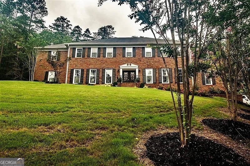 Looking for land and privacy without leaving the city? This classic brick home is nestled at the edge of the Marshall Forest, offering serenity, seclusion, and convenience. A long, winding gated driveway leads you to your own private retreat. Inside, you'll find 6 spacious bedrooms - possibly up to 8, with two primary suites (one on each level). Need flexibility? There's a large workout room and a study upstairs that can easily serve as additional bedrooms or bonus rooms. The updated kitchen features all the modern upgrades you expect, and all bathrooms have been stylishly refreshed. Entertain with ease in the huge separate dining room, a formal living room (or potential office), and a precious breakfast nook with peaceful views of the forest. Enjoy outdoor living on the new oversized deck or relax year-round in the sun room with a hot tub. With space to grow and gather, this is a home built for lasting memories - whether you're expanding your family or simply seeking a private haven in town.