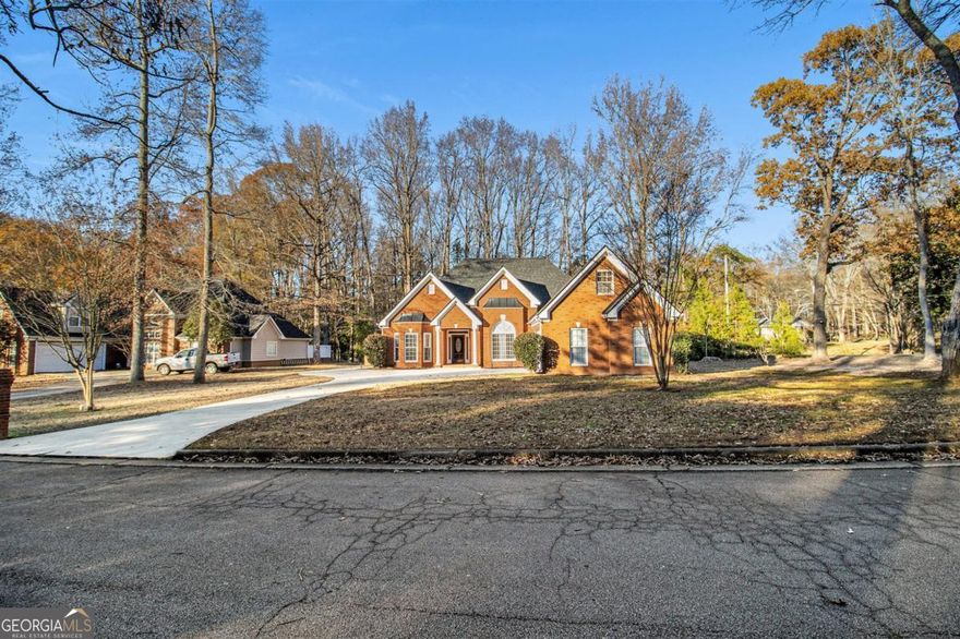 Stunning custom-designed brick-front home featuring a main-level master suite, nestled in a delightful, tight-knit community with no HOA fees. Enjoy easy access to I-20 and all the finest offerings of Rockdale County. This home boasts a brand new roof, abundant natural light from expansive bay windows, elegant archways, and soaring ceilings exceeding 12 feet throughout. The upper level includes a versatile fourth bedroom or bonus room, complete with storage and new luxury vinyl plank flooring.     The inviting eat-in kitchen is equipped with stainless steel appliances, granite countertops, tile flooring, custom cabinetry, and a convenient breakfast bar. Additional highlights of the property include an extended driveway leading to a two-car garage, a new hot water heater, and a spacious backyard with a patio ideal for entertaining, alongside a separate shed for extra storage. This home is in immaculate condition and just minutes away from Hartsfield Airport, Piedmont Rockdale, Emory Hillandale, Kaiser Permanente, local stores and restaurants.