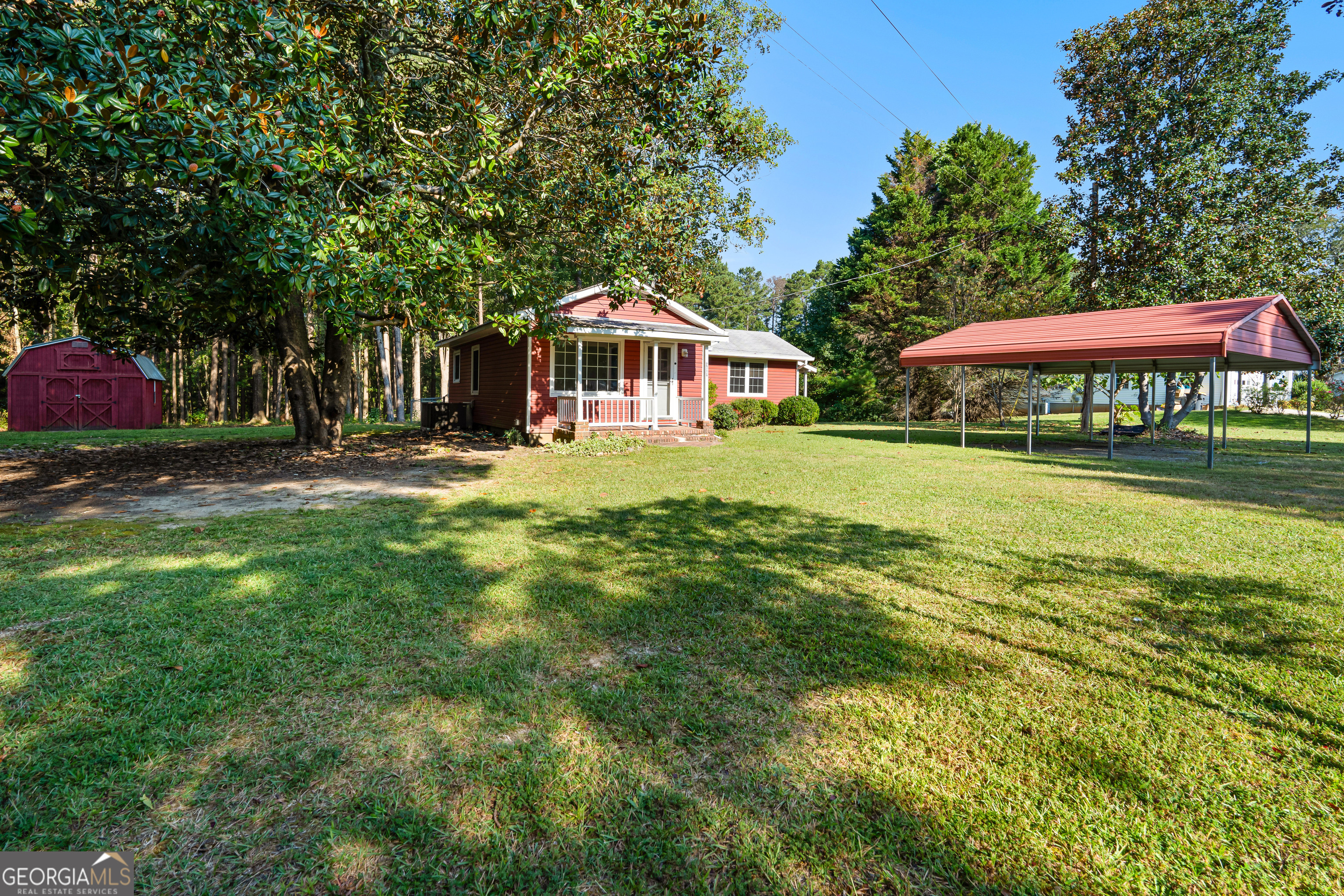 Set on a peaceful stretch of countryside yet just minutes from downtown Newnan, this charming property offers the best of both worlds-serene privacy with quick access to schools, shopping, and I-85. The family room flows effortlessly into the kitchen and dining area, making it perfect for both everyday living and entertaining. 2 bedrooms, 1 full bath. Fenced backyard, carport and barn with electricity. Great home for an investor or first time home buyer. 2.36 acres 2 lots included