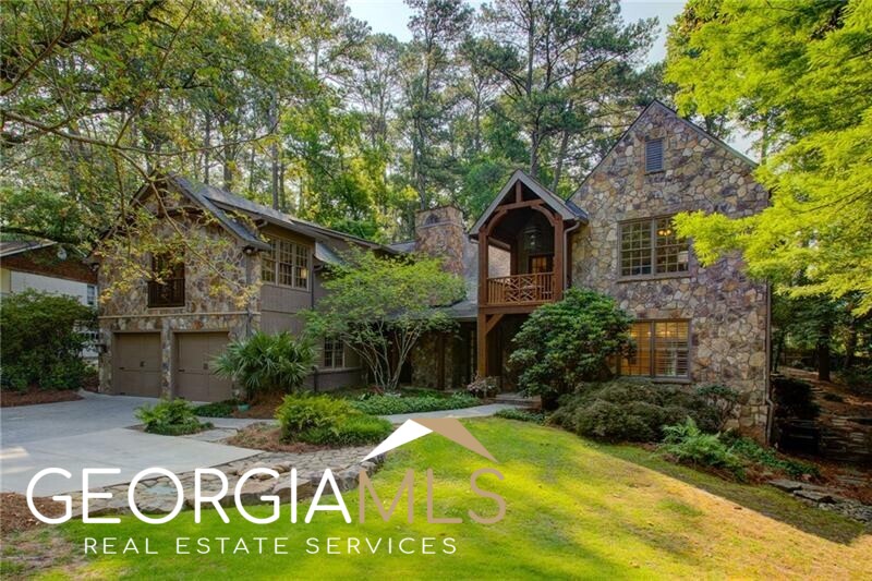 Welcome home to 691 Darlington Road! Nestled beneath the leafy tree canopy of Buckhead's sought after Peachtree Park neighborhood, European elegance meets urban seclusion on over a half-acre with the convenience of in-town living at your doorstep. Face stone and stained beam details call out French country cottage while interior finishes and features offer modern amenity. Greet guests at the covered flagstone front porch before welcoming them into a main level with gleaming hardwoods and elegant millwork. Entertain guests in the formal fireside living room or adjacent great room with vaulted ceiling and stone fireplace. The cook's kitchen features elegant cabinetry with gorgeous vent hood, down-lit showcase cabinetry detail, ample storage, oversized kitchen island, wet bar with wine fridge and separate ice maker, and appliances by Wolf and Cove. Enjoy holiday meals in the formal dining room surrounded by prominent wainscoting with pastoral views over the expansive back yard. Retire to your main-level primary suite with bright bay window, dual walk-in closets and primary bath with dual vanities, separate shower and tub, and water closet. A fantastic second level layout features a grand landing with French doors that open to the cozy upper-level front porch. Four additional bedrooms await, each with access to their own Jack-and-Jill bathrooms. Bonus space over the garage offers two rooms for the ideal home gym, rec room, yoga sanctuary, or additional bedroom space. Don't miss the upper-level laundry connections off the main hall. Enjoy the serenity of a fenced back yard complete with a wide kitchen/dining adjacent patio, mature hardwoods, and a variety of spaces ready for your vision. Have peace-of-mind with the encapsulated crawlspace beneath the home that offers standing-height space for storage or workshop. Frequent flyer? MARTA's Lindberg Station is a 5-minute off-peak drive. Be at TSA within 30-40 minutes without the hassle of the connector OR airport parking.