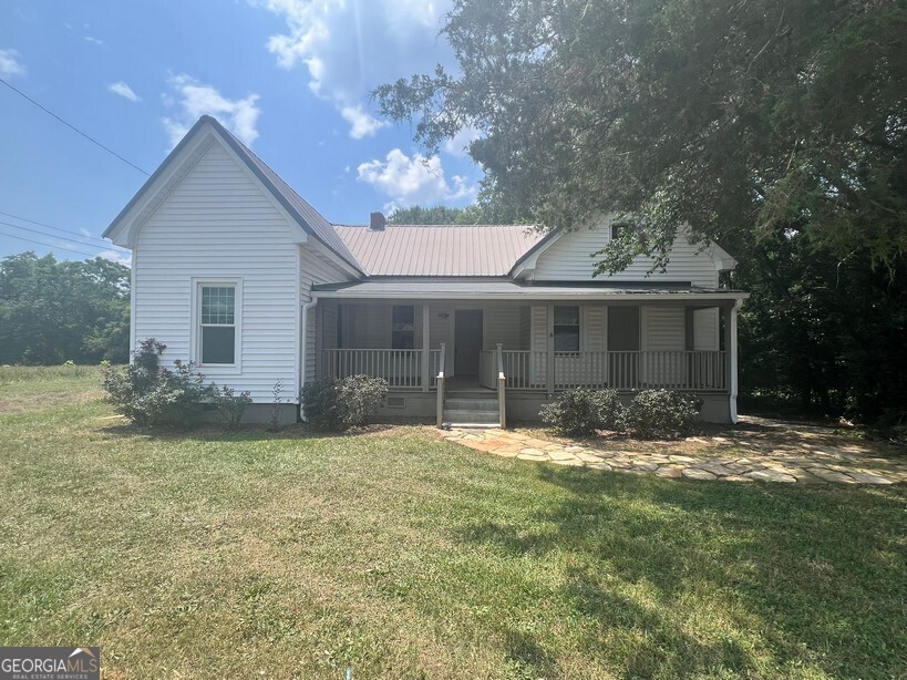 This beautifully renovated 1950s 2-bedroom, 1-bath home offers timeless character blended with modern updates, perfectly located just minutes from Oxford College, Covington Square, I-20, Piedmont Newton Hospital, and all the shopping, dining, and entertainment Covington has to offer. The home features a spacious family and a large eat-in kitchen with white appliances-perfect for everyday living or entertaining. Both bedrooms are generously sized and share a renovated bathroom. Additional features include a hardwood flooring throughout, separate laundry room, a classic rocking chair front porch, a covered back deck, and a private, fenced backyard -ideal for play or relaxing evenings outdoors.