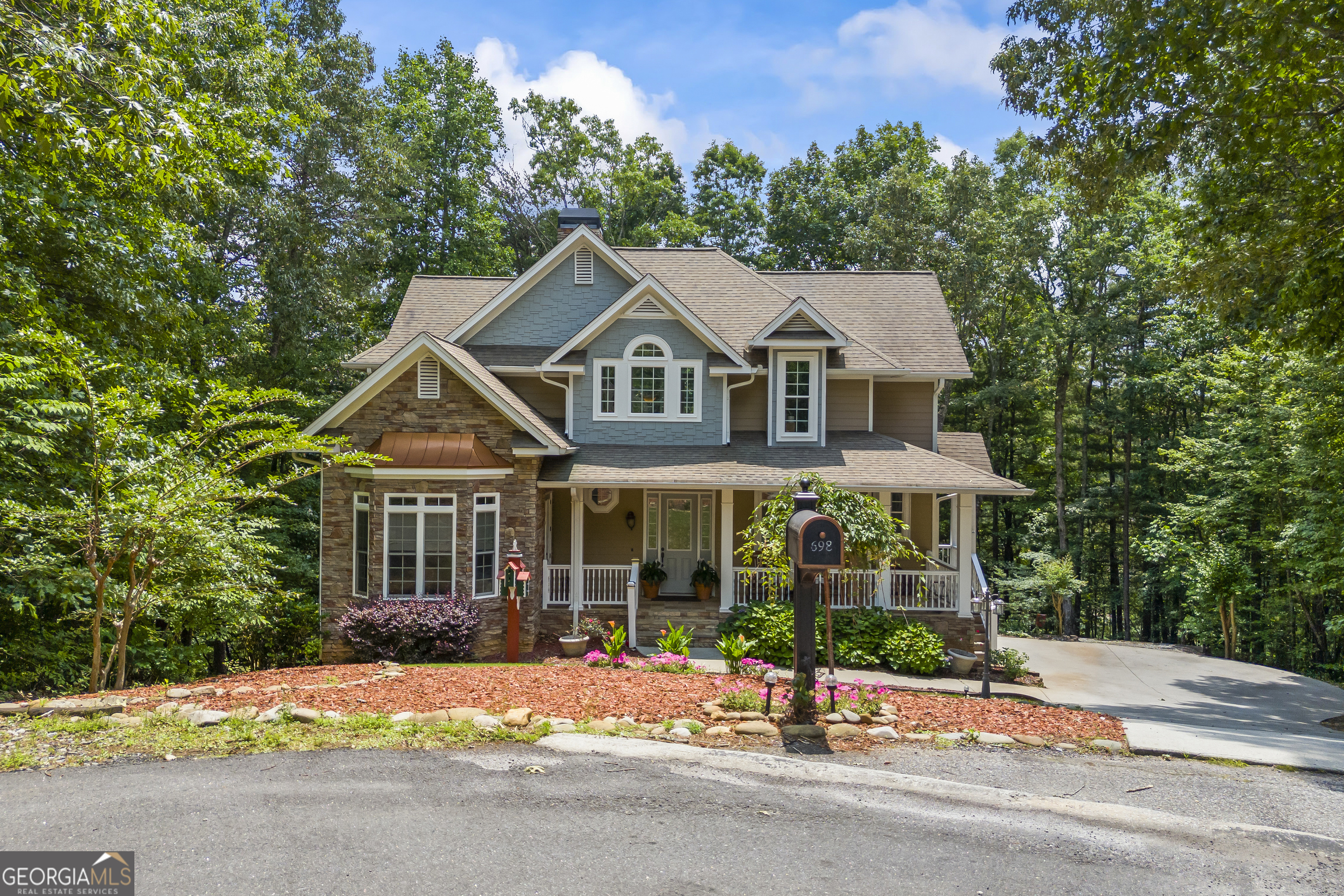Golf Course Living Meets Mountain Luxury in Helen, GA! Welcome to your dream mountain escape in the gated Innsbruck Golf Community of Helen, GA. Situated on an estate-sized lot with incredible views of not one-but two greens-this custom-built home offers room to spread out, relax, and enjoy resort-style living all year long. With five bedrooms, five and a half baths, and three fully finished levels, this property was designed for multigenerational living, unforgettable entertaining, or maximizing short-term rental potential. Inside, you'll find soaring vaulted ceilings in the main living area and kitchen, creating an open, airy feel. The kitchen is beautifully appointed with solid granite countertops, wood cabinetry, a breakfast nook, and a breakfast bar, while the adjoining formal dining area can comfortably host large gatherings. The main level features a spacious primary suite with an ensuite bath, as well as a flexible second bedroom that could serve as an office, nursery, library, or guest space-also with a full bath. Upstairs, there are two generously sized bedrooms, each with its own full bath and ample closet space. The fully finished terrace level is a standout, offering a second full kitchen, living area, bedroom, full bath, half bath, and a large workshop or art studio. Closets and storage space are abundant throughout the home, making it as practical as it is beautiful. The exterior is equally impressive. This property is beautifully landscaped and tucked under a canopy of trees, providing privacy and natural beauty. A detached backyard deck with a built-in bar overlooks the golf course, creating the perfect setting for three-season outdoor entertaining. A custom-built bocce ball court offers fun and flexibility for your favorite yard games. As a resident of the Innsbruck Golf Community, you'll enjoy access to the championship Innsbruck Golf Club and the upscale Valhalla Resort, featuring a spa, rooftop dining, fitness center, and a saltwater pool at a discounted rate as a resident. Located just minutes from downtown Helen's charming shops, restaurants, hiking trails, and wineries, this home offers the best of North Georgia mountain living. Whether you're seeking a full-time residence, a vacation getaway, or a high-performing investment property, 698 Wilfar Strasse is a must-see! **MUST enter at the Main Front Security Gate for Showings & Open House!**