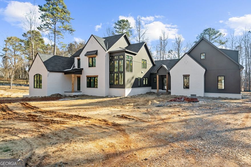 Gorgeous new construction built by Jason Hipps Homes! Perfectly situated on 4.6 acres in Cherokee County with Alpharetta address. Timeless open floor plan concept featuring 5br 5.5ba, owners suite on main with spa like bathroom, frameless glass shower, separate soaking tub, custom his and hers walk in closet. Designer kitchen with top of the line Thermador appliances, oversized island, quartz countertops, custom inset cabinetry, separate vaulted breakfast room and walk in pantry! Family room overflowing with natural light, rustic beam ceilings and brick fireplace. Expansive 16x10 California sliding glass doors leading out to the covered outdoor living area with fireplace, tongue and groove ceilings with Sonos speakers, drop brick flooring all overlooking 16x32 heated saltwater pebble tec pool with raised spa. Wide plank white oak hardwood floors throughout! Secondary level features 4 bedrooms 4 full bathrooms, loft/media room, huge bonus room over 4 car garage and ample storage space! Terrace level awaiting your finishes, can accommodate additional bedroom, wine cellar, bar, billiard room and home gym! Still time to select your own finishes, completion 3 months.