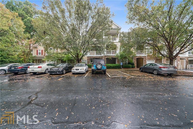 Welcome! This 2 bedroom, 2 bath Condo is located in a wonderful gated community with clubhouse, resort style pool and tennis courts. This home is in move in condition, featuring an updated kitchen with brand new stainless appliances in kitchen and all new flooring in every room! Enjoy the view to your private back covered, oversized deck, perfect for entertaining. Kitchen is open to great room, gleaming granite counters and breakfast bar. Just a short drive to MARTA, shopping, Avalon, Verizon amphitheater. This one will not last. Location! Location! Location! Owner occupants only. Garden level unit.
