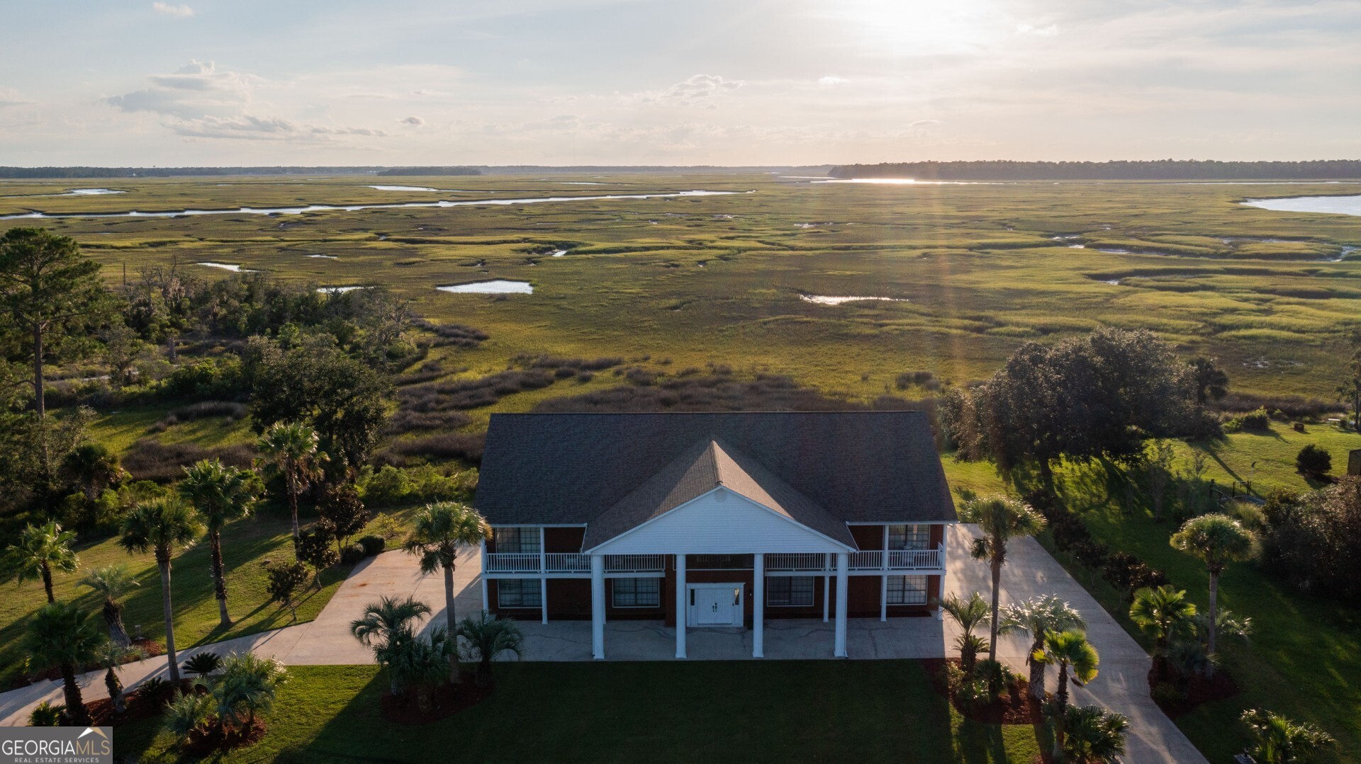 Enjoy the sunset every night! This beautiful 2-story brick home is on over an acre, located at the end of a cul-de-sac, and has stunning marsh and river views for miles! There is so much room in this home with 3 Bedrooms and 3 Baths PLUS 2 additional rooms that could be an Office and a Library, or Formal Dining Room (or whatever you need it to be), PLUS a downstairs Bonus Space with an additional 1536 sq ft. Upstairs is an open floor plan featuring a beautiful wood staircase and chandelier, hardwood floors throughout, a double-sided gas fireplace between the Living Room and Sun Room, Dining area, and so much more. The Kitchen features an island gas cooktop, double ovens, butlers pantry, plenty of cabinets, stainless steel appliances, and more. The Primary Suite features a large walk-in shower, clawfoot tub, double pedestal sinks, walk-in closet (with laundry connection too). The downstairs bonus space is heated/cooled, and there is tons of storage throughout the home and in the oversized garage. Located in Elliots Plantation, near Crooked River State Park and Boat Ramp. No HOA. No City Taxes.
