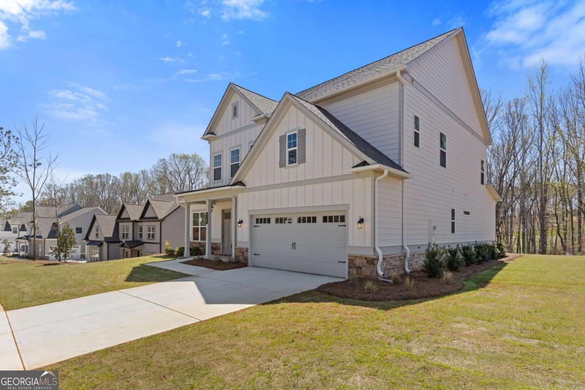 Welcome to your dream home at 3257 Traditions Way, a beautifully crafted Jamestown plan nestled in the prestigious Traditions of Braselton community. This exquisite new construction offers five spacious bedrooms and four full baths within a thoughtfully designed open-concept layout that blends timeless elegance with modern comfort. The heart of the home features a chef-inspired kitchen with granite countertops, stainless steel appliances, a large center island, and a walk-in pantry-perfectly positioned to overlook the fireside family room and sunlit dining area. A main-level bedroom and full bath provide flexible space for guests or a private office. Upstairs, retreat to the luxurious primary suite complete with a sitting area, expansive walk-in closet, and spa-like bath with dual vanities, a soaking tub, and a stunning mega shower. Enjoy outdoor living on the covered patio overlooking a serene backyard. Residents of Traditions of Braselton enjoy resort-style amenities including an Olympic-sized pool with water slide, fitness center, clubhouse, tennis and pickleball courts, walking trails, and an 18-hole golf course, all set within a vibrant and beautifully maintained master-planned community.