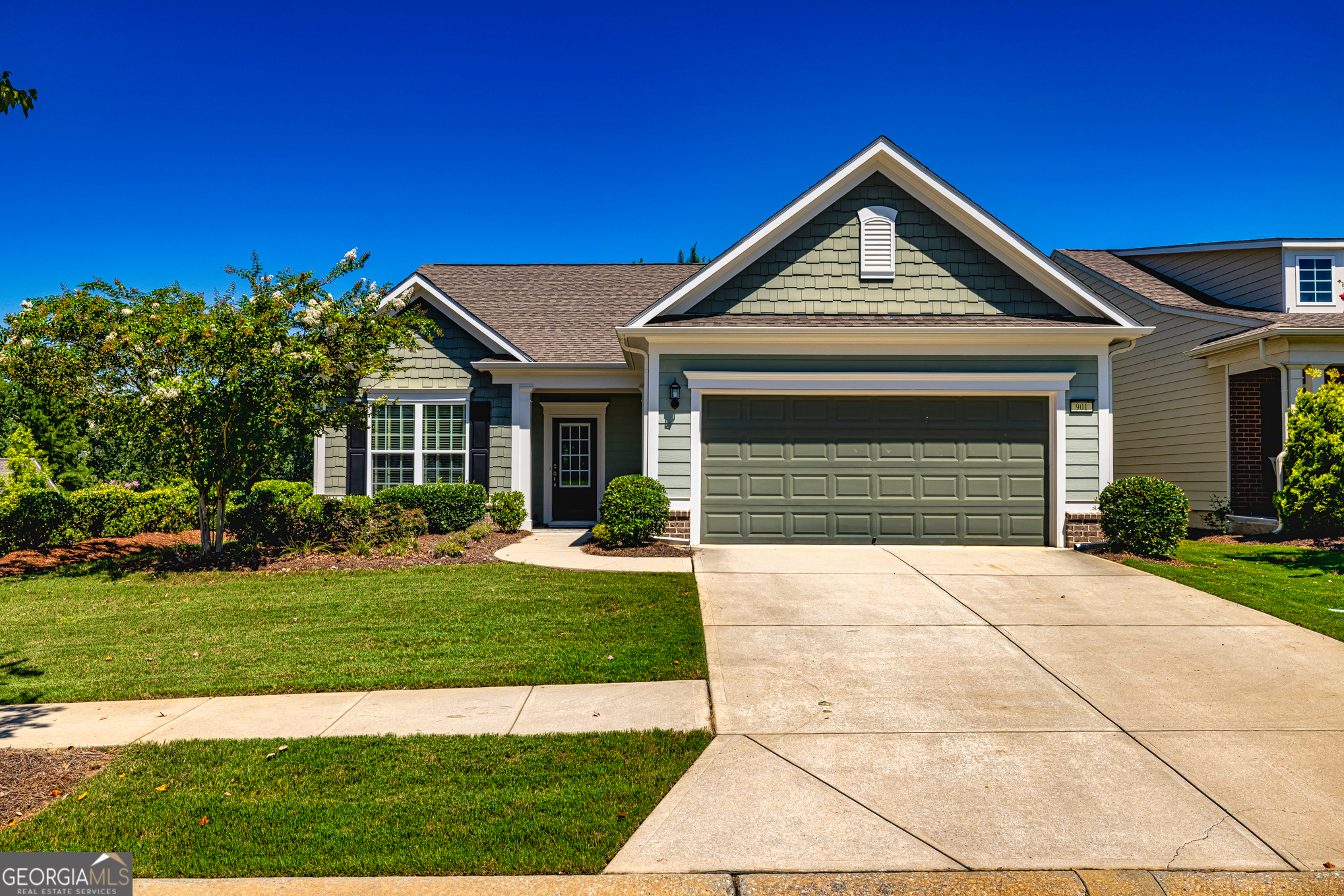 Welcome to Sun City Peachtree - Where Every Day Feels Like a Vacation! Nestled in one of the most desirable 55+ communities in the Southern Crescent, this stunning home offers more than just a place to live - it offers a lifestyle you'll love. Sun City Peachtree is a vibrant, active adult community where neighbors become friends, and every day is filled with opportunity. Whether you're looking to stay active or simply relax, you'll find everything you need right here: enjoy indoor and outdoor pools, pickleball and tennis courts, a top-tier fitness facility, a beautiful golf course, a dog park for your furry friends, a softball field, scenic walking trails, and a dynamic clubhouse packed with social events and activities. And the best part? You get to come home to your dream home - the beautifully designed Martin Ray floor plan. From the moment you step inside, you're welcomed by warm hardwood flooring and a thoughtfully designed layout. An inviting office with hardwood floors sits just off the foyer, perfect for working from home or enjoying your hobbies. The open-concept kitchen is a showstopper - featuring custom, soft-close cabinetry, under-cabinet lighting, a sleek custom vent hood, stainless steel appliances, tile backsplash, a spacious island with pendant lighting and storage, a butler's pantry, and a wall oven/microwave combo. This kitchen flows seamlessly into a dining area with a charming, mirrored accent wall and into the bright, airy family room with recessed lighting - an entertainer's dream! Step outside to a screened-in porch with tile flooring, a ceiling fan, and elegant wainscoting on the ceiling - ideal for morning coffee or evening relaxation. Just beyond is a beautifully extended patio and an additional entertaining space, all overlooking a private backyard perfect for gatherings or peaceful afternoons. The primary suite is a true retreat, complete with a tray ceiling, a luxurious en-suite bath featuring tile flooring, a walk-in tile shower with a bench seat, a linen closet, and an oversized walk-in closet with extra lighting. A second bedroom and full bath provide comfort for guests or family, while the laundry room with cabinetry and a mud sink makes everyday living easy. The home also features a two-car garage with added perks: walk-up stairs to an unfinished storage area and extra space for your golf cart.