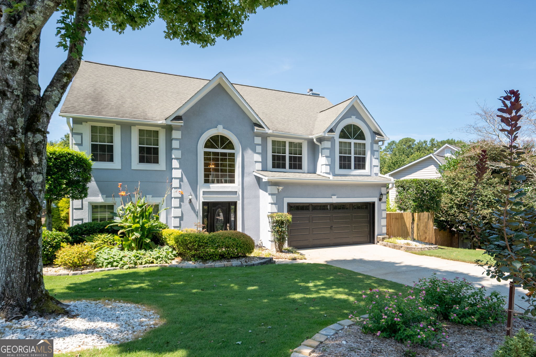 Get ready to fall in love with this 4 bedroom, 2.5 bath traditional home! Lush landscaping and great curb appeal welcome you into a two-story foyer. A versatile flex room and formal dining room set the stage, while a bright sunroom offers the perfect spot for enjoying backyard views. The kitchen opens seamlessly to the fireside family room and features white cabinetry, an island, and ample storage space. The main level also includes an updated half bath and access to the private backyard with a spacious patio and brand-new fence, the perfect space for entertaining or relaxing outdoors! Upstairs, you'll find generously sized secondary bedrooms, a shared full bath, and a convenient laundry room. The oversized primary suite is a true retreat with trey ceilings, a separate fireside sitting area, large walk-in closet, and an ensuite bath complete with his/her sinks, soaking tub, and separate shower. Enjoy the community playground and private access to Spratlin Lake, perfect for fishing, kayaking, or simply relaxing by the dock. This home is walkable to top-rated schools and just minutes from Avalon, Halcyon, Downtown Alpharetta, Johns Creek, Webb Bridge Park, Ocee Park, Big Creek Greenway, and GA-400. With nearby shopping, dining, trails, and entertainment, this location truly has it all. Don't miss out on this fantastic opportunity!!! **Reduced Costs Option: With Preferred Lender, receive up to $3500 credit toward closing costs OR 1-year interest rate buydown!