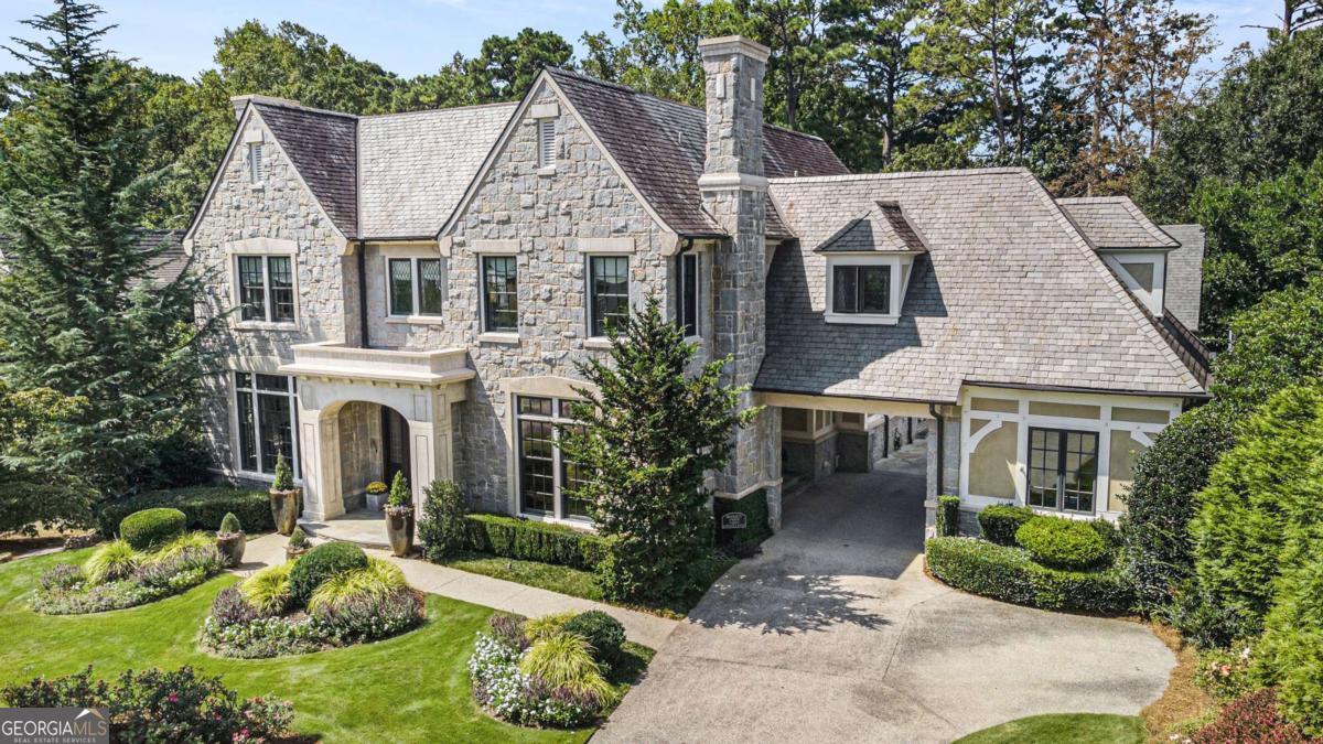 **Experience Morningside at Its Finest!** This exceptional custom-built home is situated on the highly sought-after Merton Road, known for its tranquil atmosphere and spacious sidewalks. Designed by renowned architect Frank Neeley and crafted by a respected builder of custom homes, Neil Johnson of Canonbury Homes, this one-owner residence is a true masterpiece. Every inch of this 6-bedroom, all en suite home has been thoughtfully designed for maximum enjoyment and entertaining. The stunning interiors and exteriors showcase meticulous attention to detail, making it undoubtedly one of the finest homes in Morningside. Marvel at the exquisite finishes, textures, and abundant natural light that fill the large rooms. With soaring ceilings and a smart floor plan, this home offers outstanding craftsmanship that creates a luxurious sanctuary. The impressive curb appeal features a limestone and granite facade complemented by a slate roof, copper gutters, and lush landscaping. The elegant port cochere and motor court lead to two separate garages, with a convenient one-step entry into the home. Enter through the grand foyer that opens to an oversized dining room with a fireplace and a sophisticated office with built-in bookcases and its own fireplace. The main level also includes a guest suite and two powder rooms. The magnificent kitchen with double islands, hand carved wood floors, a granite archway, and Ann Saks tiles, seamlessly connects to the great room adorned with wooden beams, a grand fireplace, and custom details. The separate breakfast room leads to a breathtaking sunroom with custom iron windows and doors, overlooking a beautifully designed outdoor entertainment area. Enjoy the expansive covered porch with a fireplace and motorized patio shade, overlooking a stunning backyard oasis featuring a large inground pool, hot tub, and a cozy fireplace seating area, all surrounded by mature trees and landscaping for privacy. Ascend the solid wood, wide central staircase to the second floor, where you'll find 10-foot domed ceilings, handsome bookshelves, and rich moldings, showcasing impeccable attention to detail. The second floor hosts four spacious bedroom suites, including a primary suite that serves as a true retreat, complete with a private outdoor patio, a large custom closet, and a luxurious spa-inspired bathroom. Three additional large guest bedroom suites and an oversized laundry room round out the upper level. The sixth bedroom suite, ideally located off the great room with a separate staircase, affords privacy for guests. The terrace level is designed for entertainment and recreation, featuring 10-foot ceilings, a home gym, a movie room with a large screen projector, a gaming area, and ample storage. A beautifully crafted teak wet bar with a third dishwasher and additional ice maker, along with a climate-controlled wine cellar, complete this level. Direct access to the pool level provides convenience with a changing area and storage for pool floats and accessories. This is a rare opportunity to own a custom-built, impeccably designed residence in one of Atlanta's most coveted walking neighborhoods. Don't miss out on this one-of-a-kind gem!