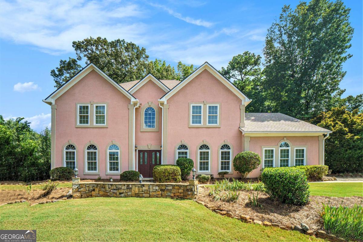 Stunning and spacious traditional home in the heart of East Cobb, offering over 3,500 square feet of thoughtfully designed living space in the top-rated Lassiter High School district. This move-in ready residence blends timeless design with modern updates, including fresh interior paint and a newly remodeled back deck that invites you to relax or entertain in style. Inside, a grand two-story foyer with travertine flooring and elegant crown molding sets the tone. The fireside family room flows seamlessly into a gourmet kitchen featuring granite countertops, a large center island, breakfast bar, walk-in pantry, and eat-in dining area-perfect for gatherings and everyday living. A formal living room with French doors provides a quiet retreat, ideal for a home office or library. Upstairs, the expansive primary suite features vaulted ceilings and a spa-like ensuite bath with dual vanities, a soaking tub, open walk-in shower, and a generous walk-in closet. Three spacious secondary bedrooms offer plenty of room and storage. The private, professionally landscaped backyard is a true retreat, with wooded views, stone terraces, raised garden beds, and space for a vegetable or herb garden. Additional features include newer exterior paint, a recently replaced roof, and a side-entry two-car garage with extra storage. Enjoy easy access to parks, shopping, dining, and all that East Cobb has to offer-plus a low annual HOA. A rare opportunity to own a beautifully updated home in one of Cobb County's most desirable communities.