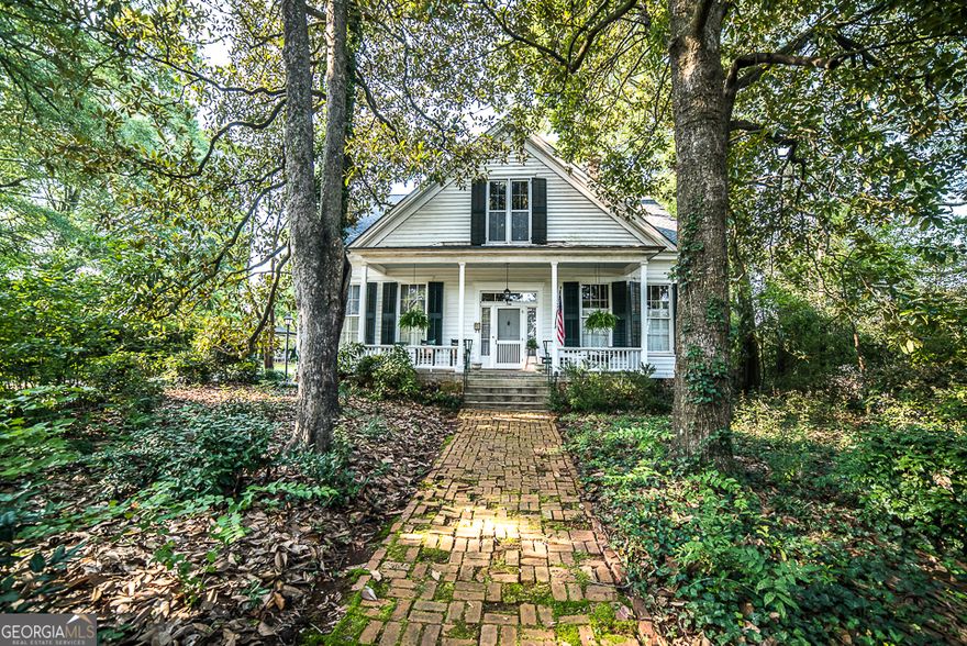 IMAGINE WAKING UP EVERY MORNING IN YOUR VERY OWN OASIS OF TRANQUILITY, WITH THE GENTLE RUSTLING OF LEAVES AND THE BIRDS CHIRPING OUTSIDE YOUR WINDOW. THIS IS WHAT LIFE IS LIKE IN THE FULLY RENOVATED AND FURNISHED 800 SQUARE FOOT, ONE-BEDROOM APARTMENT IN THIS 1867 HOME THAT IS LISTED ON THE NATIONAL REGISTER OF HISTORIC PLACES. LOCATED NEAR DOWNTOWN GRIFFIN, THE UPSTAIRS APARTMENT OFFERS A PERFECT BLEND OF OLD-WORLD CHARM AND MODERN AMENITIES. THE APARTMENT BOASTS LARGE WINDOWS THAT ALLOW AMPLE NATURAL LIGHT TO FLOOD THE SPACE, CREATING AN AIRY AND INVITING ATMOSPHERE. THE SPACIOUS BEDROOM HAS A COZY AND COMFORTABLE FEEL . THE ANTIQUE KING BED IS FLANKED BY MODERN LAMPS AND CHINOISERIE PRINTS. IN ADDITION TO THE VINTAGE DRESSERS AND BEDROOM CLOSET, A 10X10 STORAGE AREA SITS JUST OFF THE HALLWAY, PROVIDING AMPLE ROOM FOR ALL OF YOUR THINGS. A WARM AND INVITING STUDY IS COMPLETED WITH TASTEFUL DECOR. THE HIGH CEILINGS, STYLISH FLOOR LAMP AND NATURAL LIGHT MAKE THIS SPACE PERFECT FOR READING, RELAXING OR ENTERTAINING. THE GALLEY KITCHEN IS DELIGHTFUL AND FEATURES BUTCHER BLOCK COUNTERTOPS, NEW APPLIANCES, GAS COOKING AND A COFFEE BAR. THE CHANDELIER LIGHTING AND GALLERY WALL CREATE THE AMBIANCE OF DINING IN A EUROPEAN CAFE. WHETHER YOU ARE WHIPPING UP A QUICK BREAKFAST OR HOSTING A DINNER PARTY FOR FRIENDS, THIS KITCHEN HAS EVERYTHING YOU NEED T O CREATE A MEMORABLE DINING EXPERIENCE. THE BATHROOM OFFERS A SPA FEEL WITH ITS CRISP, WHITE WALLS, STUNNING TILED FLOORS, WELL-PLACED ACCENTS AND PLUSH TOWELS. THE APARTMENT INCLUDES A PRIVATE ENTRANCE, MAKING IT EASY TO COME AND GO A S YOU PLEASE. IN ADDITION TO THE APARTMENT'S STUNNING INTERIOR, THE PROPERTY OFFERS BEAUTIFUL OUTDOOR SPACES FOR YOU TO ENJOY. THE PARKLIKE SETTING PROVIDES A PEACEFUL RETREAT FROM THE HUSTLE AND BUSTLE OF CITY LIFE, WITH PLENTY OF GREENERY AND A SENSE OF SERENITY. OVERALL, THIS RENOVATED ONE-BEDROOM UPSTAIRS APARTMENT IS A PERFECT HAVEN FOR THOSE SEEKING A TRANQUIL AND COMFORTABLE PLACE TO CALL HOME