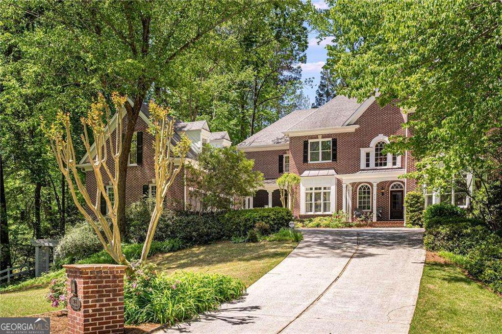You will be enchanted by this elegant traditional all-brick home sitting on a quiet cul-de-sac in Historic Brookhaven. A front facade so appealing with its long driveway and attached garage sitting to the side of the home. Enter to a light-filled two-story foyer leading to a grand staircase with four generously sized rooms upstairs. A large office accented with an arched entry, a wet bar, and new lighting sits on the main level. The formal living room is adorned with fireplace, wet bar, built-in shelving and a walk-out to the brick patio and garden in back. An open floor plan from the kitchen features an extra-large breakfast counter and island, double ovens, a walk-in pantry, a breakfast dining nook, and an exceptionally large keeping room with fireplace. Lots of windows let the light into these spaces making for a cheery setting. You won't want to miss the dining room, ready for your guests, with room for 12. This home also features a powder room on the main level. Traverse upstairs to the enormous owners' suite beautifully accented with its "juliet" balcony overlooking the garden out back. His and Hers Closets make for easy organizing. The owners' bath includes double vanities, separate walk-in shower, and a whirlpool tub. Concerned about storage? You will love the huge walk-up attic on the 3rd level. A finished daylight basement awaits ready to accommodate your every interest with its generously sized fitness room, full bedroom and bath, pool room, second pantry area, and media room. Invite your guests. They will love the guest bedroom and bath over the garage; also an ideal au pair suite. You will not want to miss the peaceful outdoor spaces on this property - a bricked terrace patio out back, a whirlpool tub for relaxing, a juliet balcony off the owners' suite, a deck off the side of the home, and a screened in porch. Quiet, peaceful, serenity - you have it at 978 Moores Club Place.