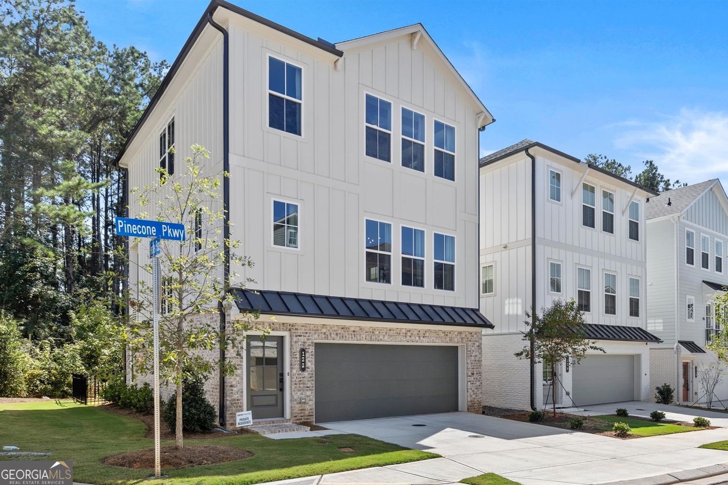 Experience modern luxury and everyday comfort in this beautiful three-story home in the new Pinecone development by Empire Communities. Situated on a corner lot, the home enjoys abundant natural light throughout, along with a private backyard, covered deck, and a two-car garage. Every detail has been thoughtfully selected with over $63,000 in premium upgrades, including box beams and a barn door in the owner's suite, shiplap ceilings, luxury cabinetry, quartz countertops, premium appliances, designer lighting, and wide-plank luxury vinyl flooring throughout. Each element has been designed to blend elegance, comfort, and practicality, making this home truly remarkable. Pinecone park is more than a neighborhood - it's a lifestyle. Residents enjoy a sparkling community pool, welcoming clubhouse, community garden, and a direct trail to Rock Mill Park and the Greenway, perfect for morning walks, evening jogs, or weekend adventures. Centrally located at the intersection of Kimball Bridge and North Point Pkwy, you're just minutes from shopping, dining and entertainment, all while enjoying the privacy and serenity of this thoughtfully designed community. This home is not just a place to live - it's a place to thrive, create memories, and experience the best of Alpharetta living.