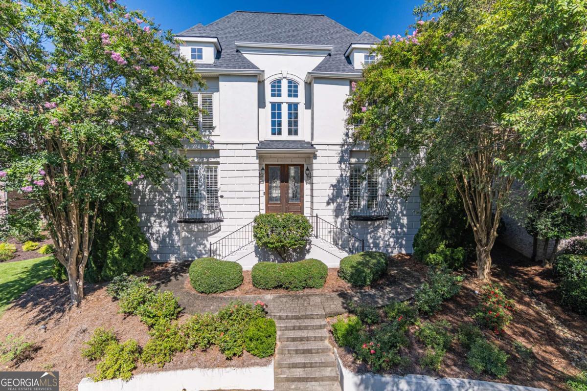 Your dream home awaits you! Secure your opportunity to claim a one-of-a-kind luxury French Tudor in Chateau Elan's Oxley Village. This house has incredible curb appeal. As you step inside you'll be captivated by the grand 2 story foyer and abundant natural light that warms the entire house. A beautiful master suite sits off the front entry with french doors and a private balcony looking out over Oxley Village. The open-concept kitchen is equipped with Viking appliances, a butlers pantry and an island for three. Downstairs you will find a child's oasis. A custom built kids playhouse and theater awaits you in this incredibly finished basement. The detached garage features a finished bonus room above for a home office or private suite. Incredible equity potential with the new Arcadia 347 development happening walking distance from the house. Don't miss your chance at this rare opportunity to secure your next home in the beautiful Chateau Elan neighborhood. Schedule your showing today!