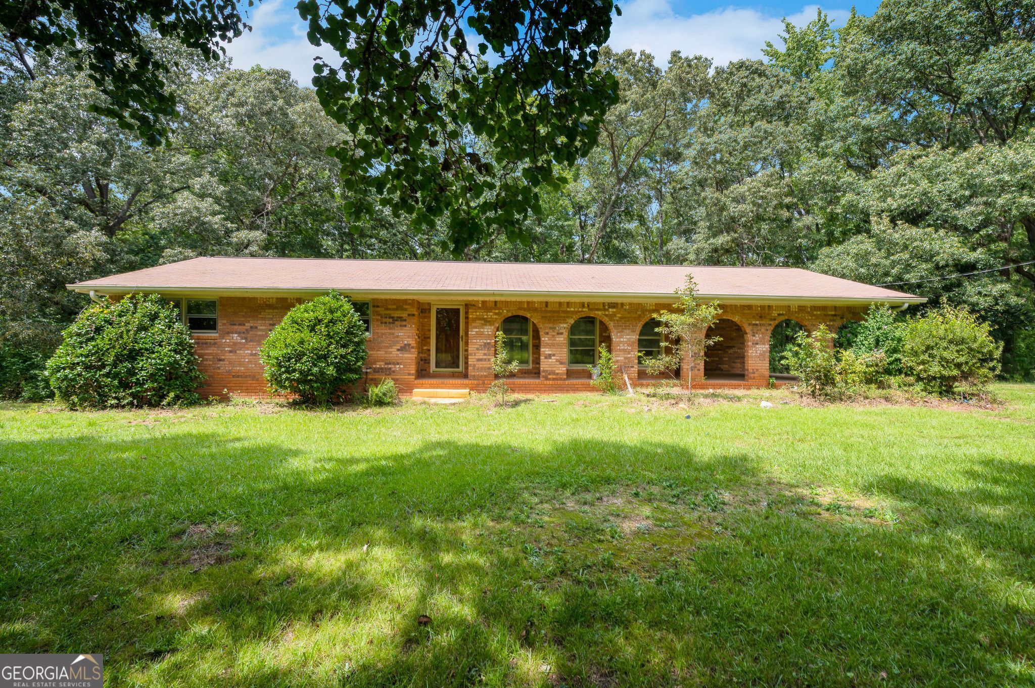 If you're looking for privacy, this brick home on almost 5.5 acres in Hampton is hard to beat. The property sits back from the road and has a quiet, peaceful feel with plenty of space around it. There's a carport and a beautiful sunroom that looks out into the woods-perfect for relaxing and enjoying the view. Inside, the house has been recently updated with fresh paint, new LVP flooring, modern kitchen countertops, a tile backsplash, and updated light fixtures. It's clean, bright, and ready to move into. The only thing it still needs is an AC unit, which the seller is willing to install with a reasonable offer. On the property you'll also find a solid metal outbuilding with a roll-up garage door-great for storage, hobbies, or even a workshop. The surrounding area has a lot of horses and other animals, giving it a country feel, while still being close to both Atlanta and Griffin for an easy drive into town. This home offers a rare mix of seclusion, updates, and usable land-ready for its next owner to enjoy.