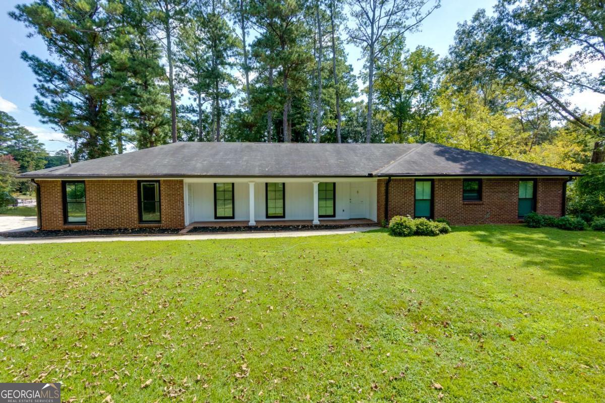 Looking for a charming ranch in the heart of Marietta with NO HOA and completely updated? Look no more! This classic one level home features 4 bedrooms and 2 full bathrooms. Enter the home into a foyer to be greeted with loads of natural light, updated flooring, and neutral paint throughout with a spacious floor plan. Just off the foyer you will enjoy a large den perfect for entertaining or unwinding, as it it attached to the formal dining room. This den space could easily be converted into a flex space for a home office, playroom, or study. The dining room is spacious, has updated lighting, and joins the kitchen for your convenience. The kitchen offers wood cabinets, granite countertops, white tile backsplash, and updated stainless steel appliances. There is also a casual dining space in the kitchen with a great view into the backyard. Continue on to the primary suite where you will enjoy a generous sized bedroom complete with closet and en suite bath. The master bath offers a beautiful walk in tile shower, updated vanity & mirror, and new fixtures. The additional 3 bedrooms are also spacious and share the second full bath with shower-tub combo, updated fixtures, and vanity. This home also offers a laundry room just off the kitchen with additional storage cabinets, counter space, and a brand new washer & dryer that are included with the home! Take in the outdoors with a sprawling lot featuring a back patio, fenced yard, and established shrubbery and trees. This home offers loads of curb appeal with a classic brick front, covered front porch, a large front yard, and easy to maintain landscaping. A brand new driveway leads to the side entry, two car garage where you will find additional storage space within. There is also a shed in the backyard for additional outdoor storage. Updates Include: New HVAC, new washer & dryer, updated appliances, new outlets, new fixtures, new driveway, and a complete renovation that includes new flooring and paint, professionally installed new insulation throughout, and brand new windows throughout making this property highly energy efficient and helping to reduce those utility bills in both Summer and Winter. This home truly offers it all in a highly sought after area of East Cobb with easy access to local shops, restaurants, top rated schools including Pope High School (rated 9/10), and easy commutes! Area highlights include fantastic local parks and community areas such as Marietta Square, The Atlanta Braves Battery, and more.