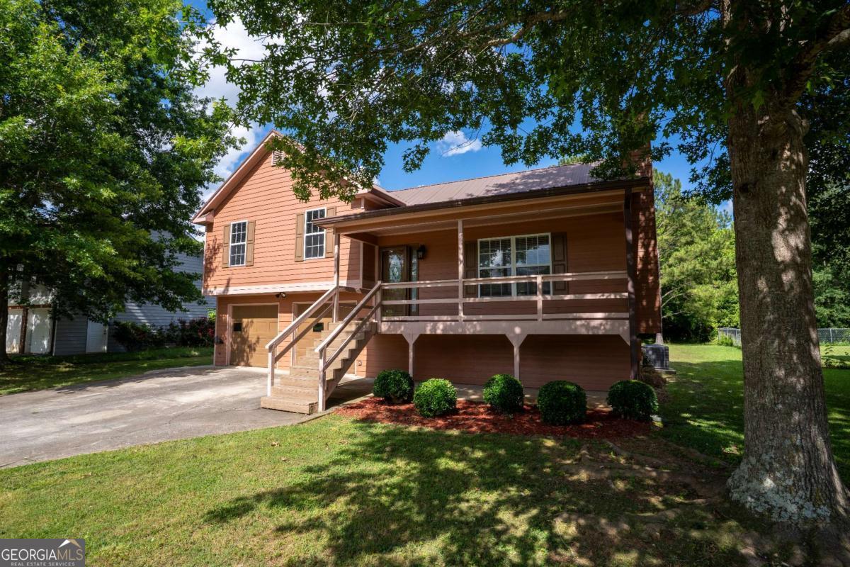 Beautifully Customized Home. Don't miss your chance to own this stunning, multi-level traditional home within Rockmart's city limits. It offers comfort, convenience, and timeless style at an unbeatable price. As you arrive, you'll immediately notice the charming covered front porch-a rare feature in the neighborhood-perfect for relaxing and enjoying quiet mornings or sunsets. Step inside to find gorgeous hardwood floors, striking stone accent walls, and sun-drenched living spaces that create a warm and welcoming atmosphere. This thoughtfully updated home features three spacious bedrooms, two fully remodeled bathrooms, and a versatile, oversized bonus room that is ideal for a game room, media space, home gym, or extra storage, offering endless possibilities. The kitchen is stylish and functional, boasting granite countertops, freshly painted cabinetry, and elegant tile flooring. The cozy family room provides the perfect spot to unwind, complete with a charming fireplace and fresh interior paint throughout. Retreat to the primary suite, where you'll find a modern, upgraded bathroom with a double-sink vanity and tasteful finishes. Step outside to a generous backyard, ready for your personal touch-perfect for entertaining, gardening, or simply enjoying the outdoors. Conveniently located just minutes from Hwy 113 and Hwy 278, you're close to local shops, restaurants, schools, banks, and more-everything you need is within easy reach. NO HOA and qualifies for 0% Down financing! Schedule your private tour today and discover all that this beautiful Rockmart home has to offer!