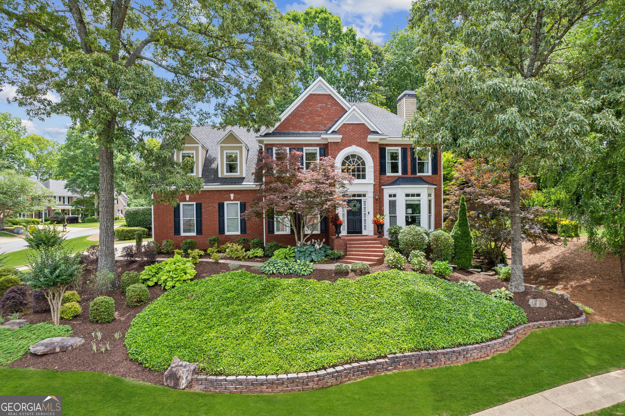 **SELLER TO CONTRIBUTE $10,000 toward the buyer's closing costs, prepaids, or rate buy-down with an accepted offer. The preferred lender is offering a lender credit of 1% of the loan amount. Contact the listing agent for more details and to be connected with the preferred lender. ** Nestled on a desirable corner lot in a vibrant swim/tennis community with an award-winning school system, this beautifully updated 4-bedroom, 3.5-bath traditional brick-front home offers space, style, and functionality. A welcoming two-story foyer with a graceful staircase sets the tone upon entry. The fullyhardwood main level features a formal dining room with a tray ceiling, and a flexible formal living room that doubles as a perfect home office. The bright white kitchen includes an L-shaped breakfast bar, built-in desk, and a cozy sitting area ideal for casual dining or morning coffee. The open-concept family room invites relaxation with a gas starter fireplace framed by built-in bookcases, and access to an additional rear staircase for added convenience. Upstairs, the spacious primary suite features hardwood floors, a tray ceiling, two walk-in closets, and a luxurious en suite bath with dual vanities, a soaking tub, and separate shower. Three additional generously sized bedrooms share a full bathroom with dual entrances, offering both privacy and convenience for family or guests. The finished basement expands the living space with a large open area perfect for media or game nights, two versatile rooms that can serve as an office, gym, or guest rooms, built-in cabinetry, a beverage fridge, and a full bathroom ideal for entertaining or extended stays. Step outside to your own private backyard retreat. Both front and back yards are serviced by an irrigation system and landscape lighting. The fully fenced backyard garden oasis features a large stone patio, built-in fire pit, dedicated gas line for your grill, and space for a play-set perfect for relaxing, entertaining, or family fun. Enjoy the resort-style community amenities including a swimming pool with waterslide, tennis and pickleball courts, basketball court, and playground. This exceptional home combines timeless elegance with modern updates and is ready to welcome you home. Brand new water heater! The following items are negotiable: washer/dryer, outdoor furniture, some basement furniture, pool table.