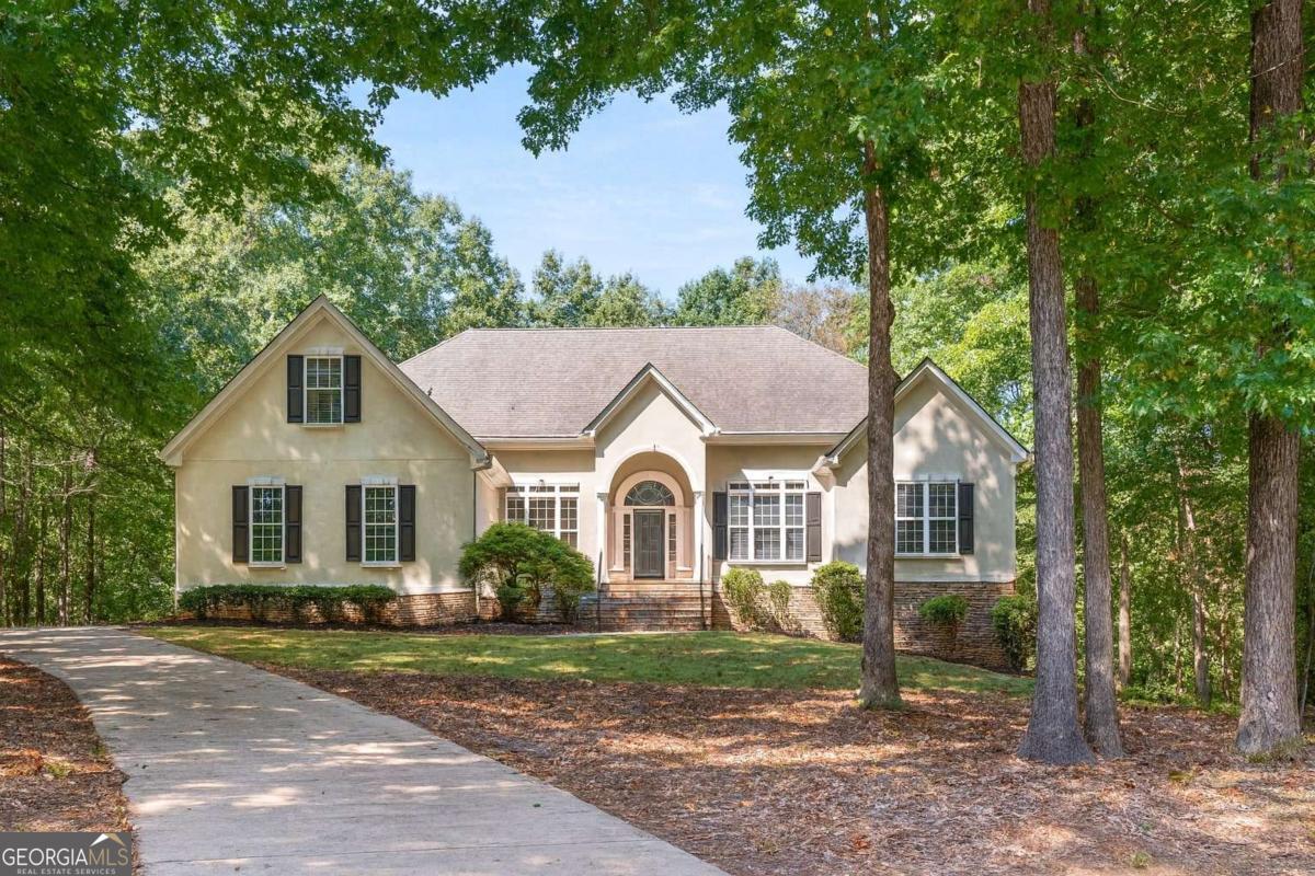 Tucked away at the end of a peaceful cul-de-sac, this spacious 5 bedroom, 3.5 bathroom home has been beautifully updated and is truly move-in ready. From the moment you step inside, you'll notice the thoughtful upgrades: fresh paint throughout, brand-new stained flooring, modern color-changing light fixtures, and new plush carpet upstairs. Enjoy the convenience of a master suite on the main floor, complete with a private ensuite retreat. The main level also features two additional bedrooms, a formal dining room, a grand family room, and an inviting open-concept living area that flows seamlessly into the large kitchen. The chef's kitchen is designed for gatherings, featuring sleek countertops, ample cabinetry, a large island, and fresh lighting upgrades. Head upstairs to find another spacious bedroom with soaring cathedral ceilings-perfect as a guest suite, teen retreat, or creative studio. The fully finished basement is where the fun begins! You'll have: Four versatile bonus rooms to use as extra bedrooms, a gym, office, or playroom. A huge den made for movie nights, game days, or the ultimate hangout spot. A workshop with exterior access, ideal for hobbies or DIY projects. A bonus room with indoor monkey bars-yes, you read that right! Perfect for kids or a unique home gym feature. Step out onto the freshly stained deck and soak in your private, tree-lined backyard. Even better-you've got your very own cozy bonfire area, with firewood already ready to go. Imagine fall nights roasting marshmallows, laughing with friends, and creating memories right in your backyard. Enjoy the best of both worlds: quiet cul-de-sac living with quick access to everything you need. You're just minutes from Peachtree City, Shops & dining, Grocery Stores, and easy access to I-85 for a smooth commute. With five bedrooms, endless bonus space, updated finishes, and an entertainer's backyard, 5 Ryans Ct checks every box. Don't wait, schedule your private showing today and see why this Sharpsburg gem is the one!