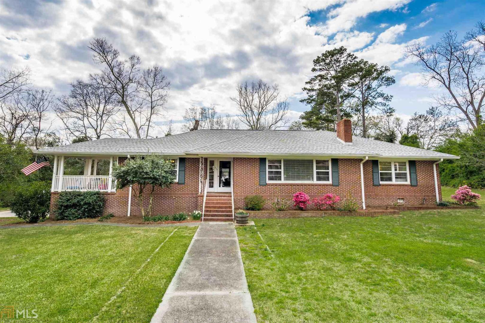 Greet the spring in a new home. This 3BR/2BA, 2475 sq ft brick home has much to offer! Features include living room with fireplace, kitchen with stainless appliances and breakfast area, separate dining area, 3 spacious bedrooms, hardwood floors, storm windows, security system, port hole front door, great side porch and 1 car garage. In the basement area there is a possible bedroom and bath. Large back yard for kids and all within walking distance to the activities Eatonton has to offer. Outstanding Buy!