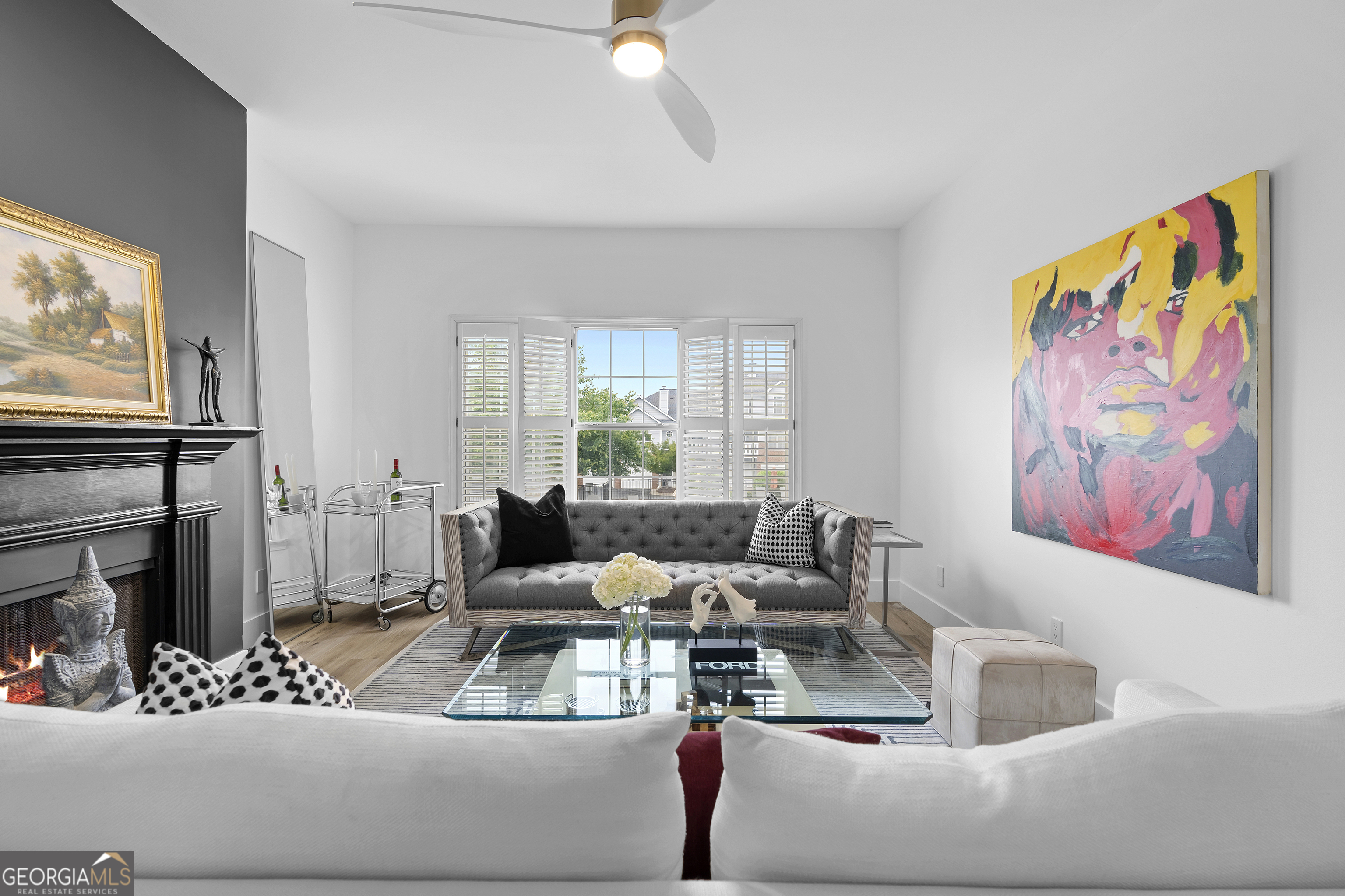 NEW EVERYTHING - COMPLETELY RENOVATED! Experience the luxury and feel of a brand new construction in this completely gutted and reimagined 3 bedroom, 2.5 bathroom home where every detail has been meticulously updated. From the ground up, this unit boasts all new plumbing, electrical, and top-of-the-line finishes throughout, ensuring a modern, worry free living experience. Inside you'll find gorgeous LVP flooring that flows seamlessly throughout, enhanced by tall baseboards. The jaw dropping kitchen is a chef's dream with high end cabinetry featuring hidden handle, soft-close cabinets and drawers, plenty of counter space, and brand new stainless steel appliances including a low profile, over the range, microwave. Enjoy casual dining at the breakfast bar with seating for two or dining area just off the kitchen with french doors opening to a balcony with a serene pool view, ideal for a morning coffee or unwinding in the evening. The spacious family room is anchored by a cozy fireplace, creating a perfect gathering space just off the entry. The primary suite is a private retreat with a dramatically expanded walk in closet and a spa inspired bathroom complete with an oversized soaking tub, stunning large format tile, and designer finishes. The other two additional bedrooms also have custom closets with built-ins for even more storage space! The guest bathroom has been reconfigured to create a more open, airy feel, while the powder room is fully refreshed with modern touches. Additional upgrades include new door handles, smart switches compatible with Alexa and Google, and fresh paint throughout. The deep 2 car garage leaves you with even more storage space or a place to park a motorcycle/golf cart in addition to two vehicles. Enjoy the community's exclusive amenities, including a private, fenced in dog park. Situated in a prime location with quick access to The Battery, Truist Park, and Smyrna Market Village, plus easy connectivity to I-75/I-285 for around a 20 minute drive to the airport for frequent travelers! This home only needs you!